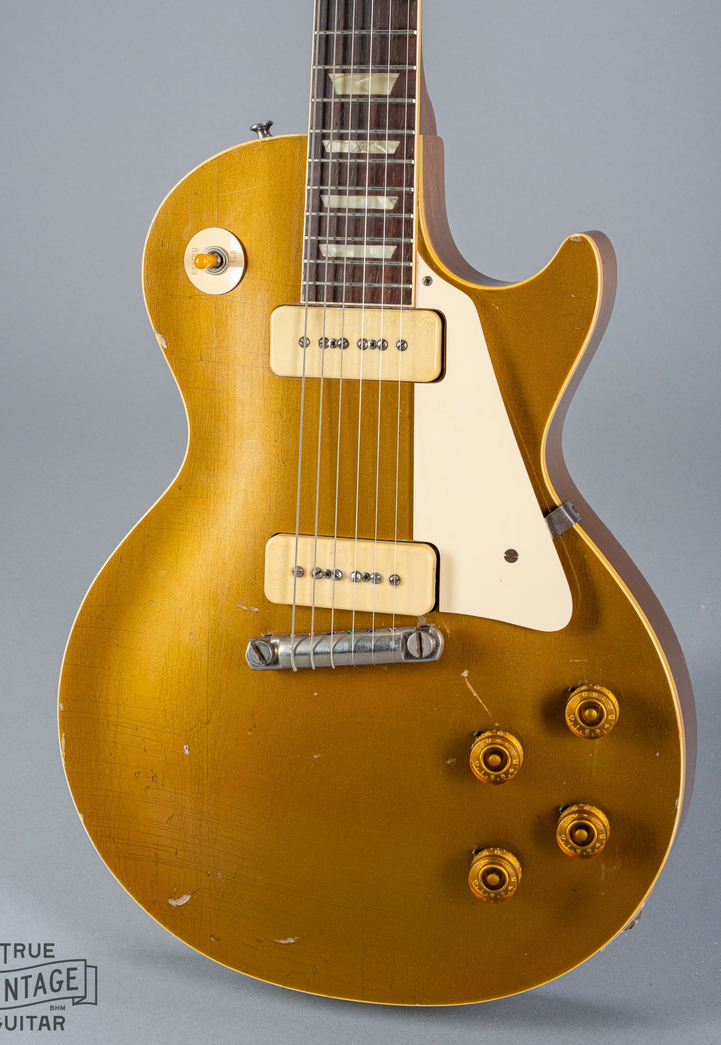 front of 1954 Gibson Les Paul Standard Goldtop guitar body p90 pickups checking switch tip fretboard inlays binding