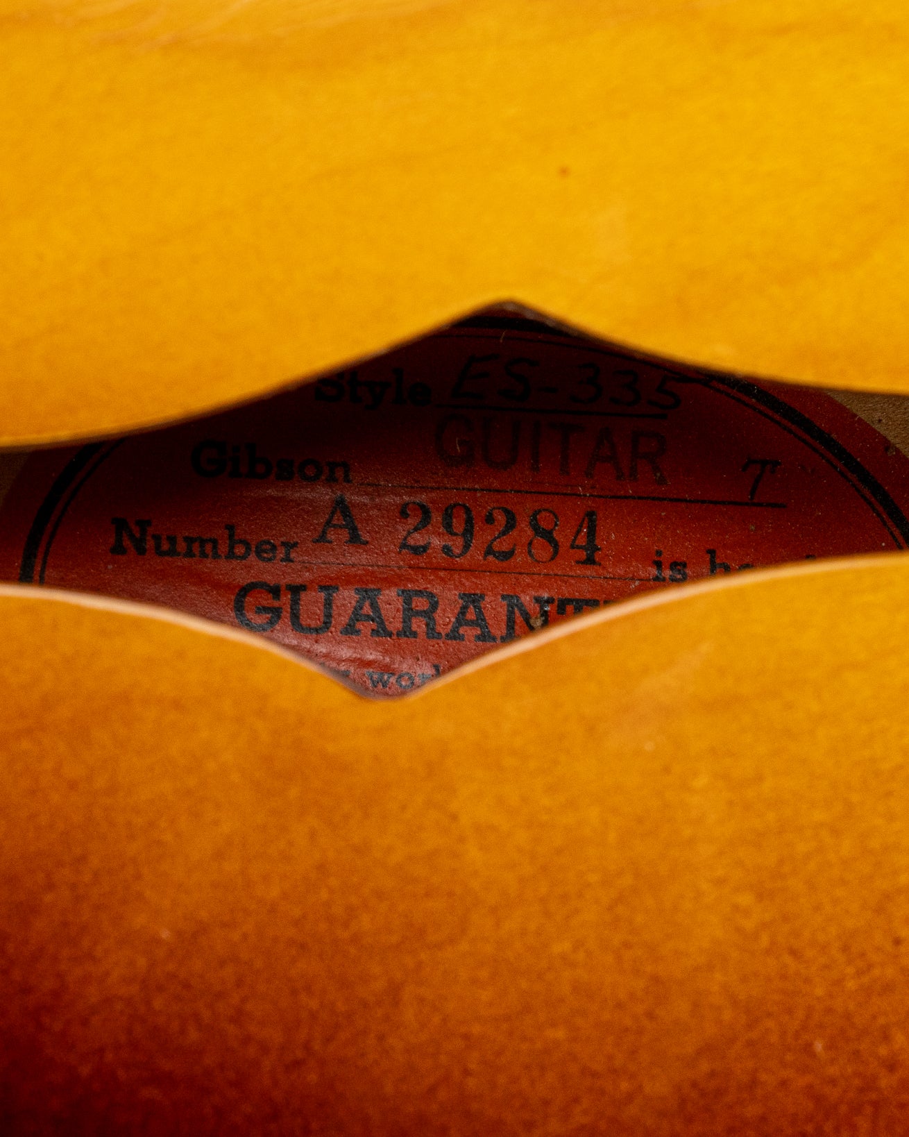 Orange oval label with serial number of 1959 Gibson ES-335