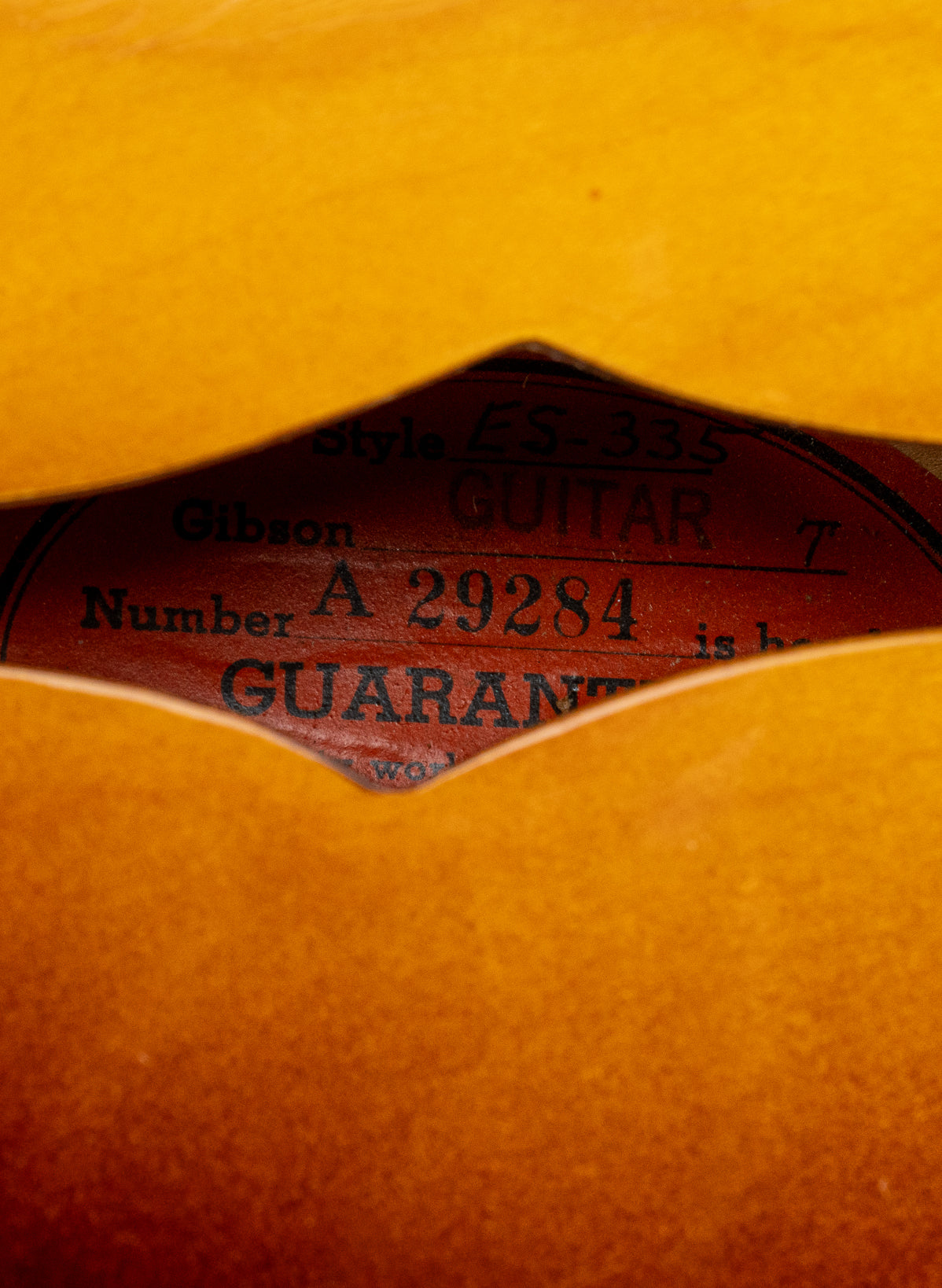 Orange oval label with serial number of 1959 Gibson ES-335