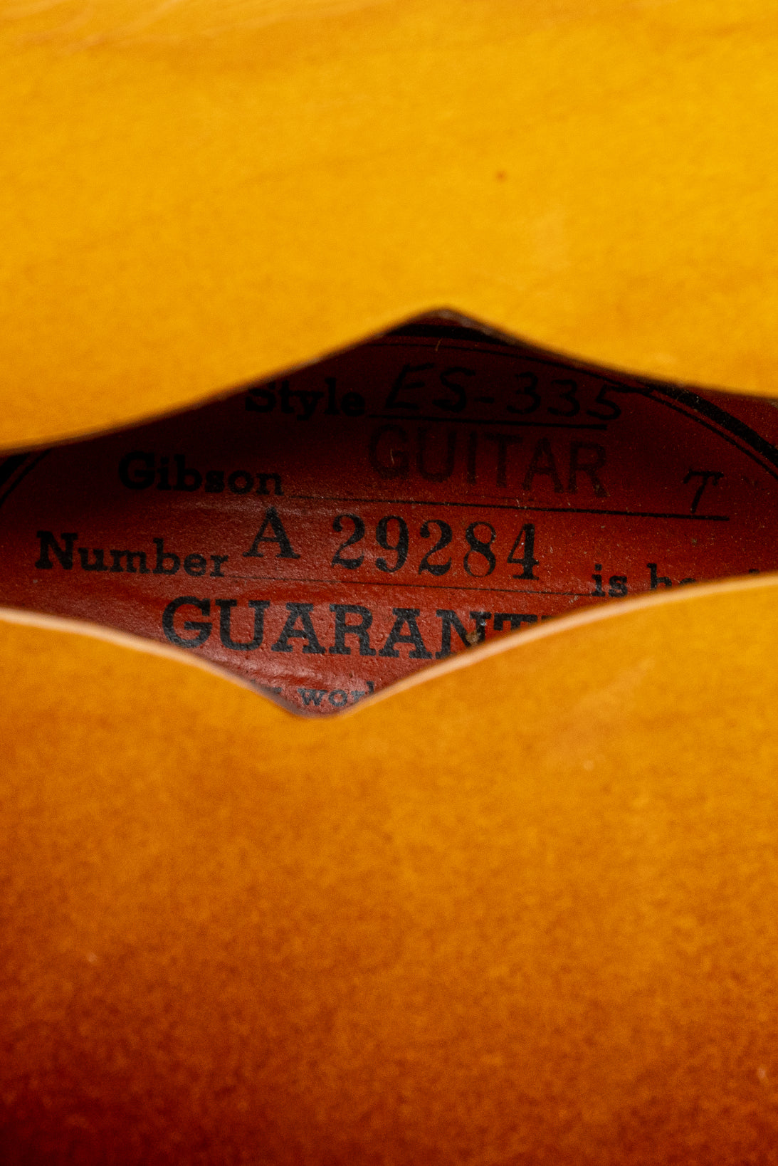 Orange oval label with serial number of 1959 Gibson ES-335
