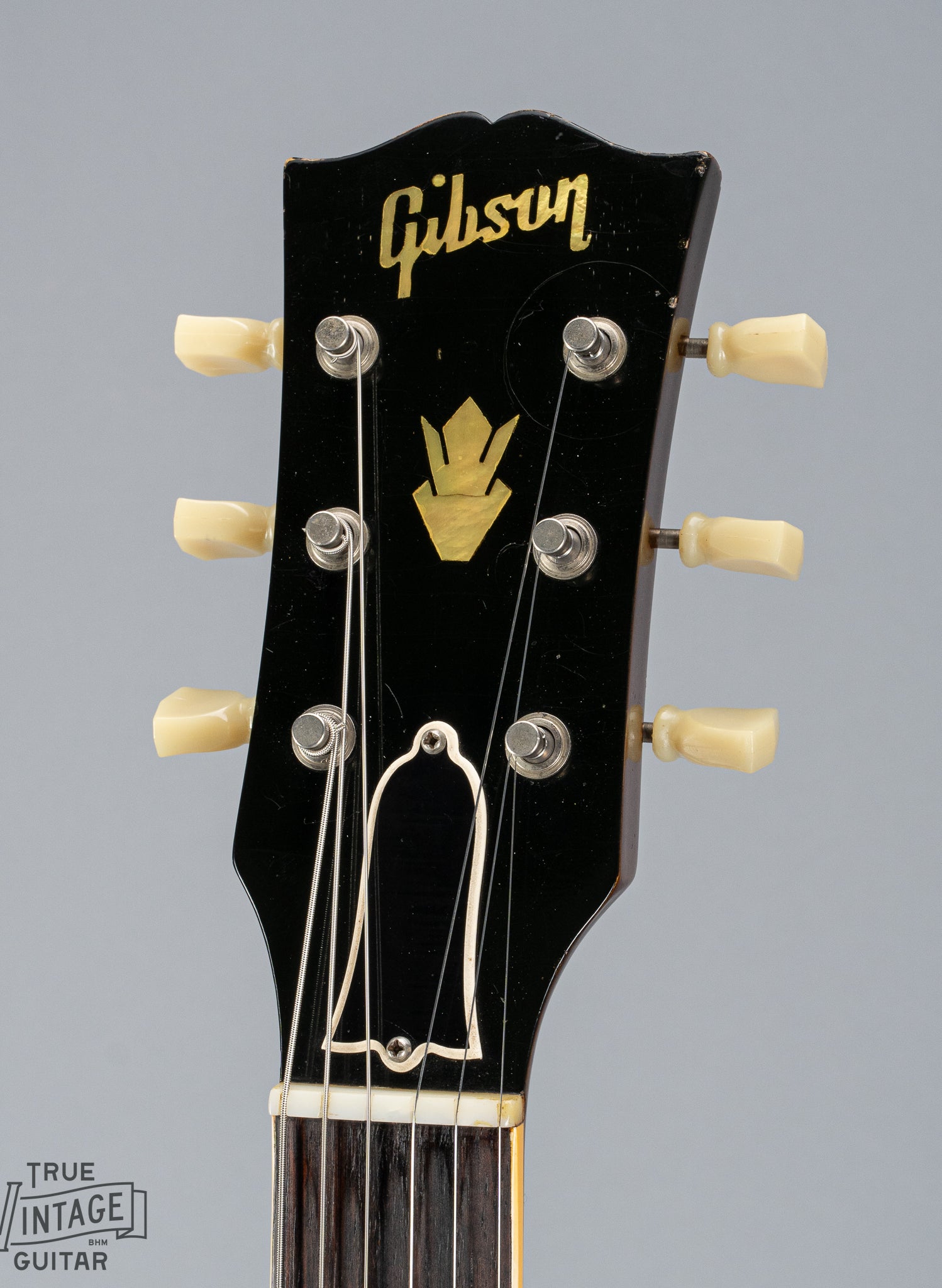 This image shows the front of the headstock of a 1959 Gibson ES-335 with pearl Gibson inlay