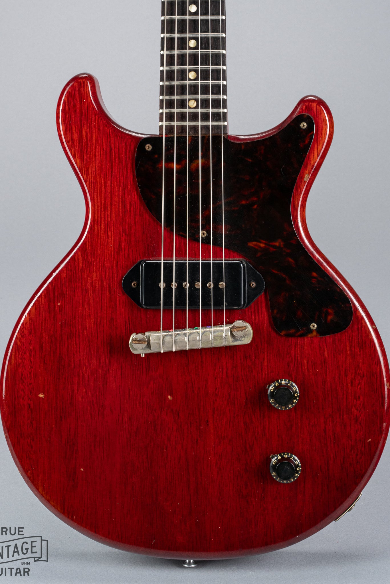 Front of 1959 Gibson Les Paul Junior cherry guitar dog ear p90 pickup tortoise pickguard volume and tone controls wrap around tail piece bridge fretboard original frets inlays