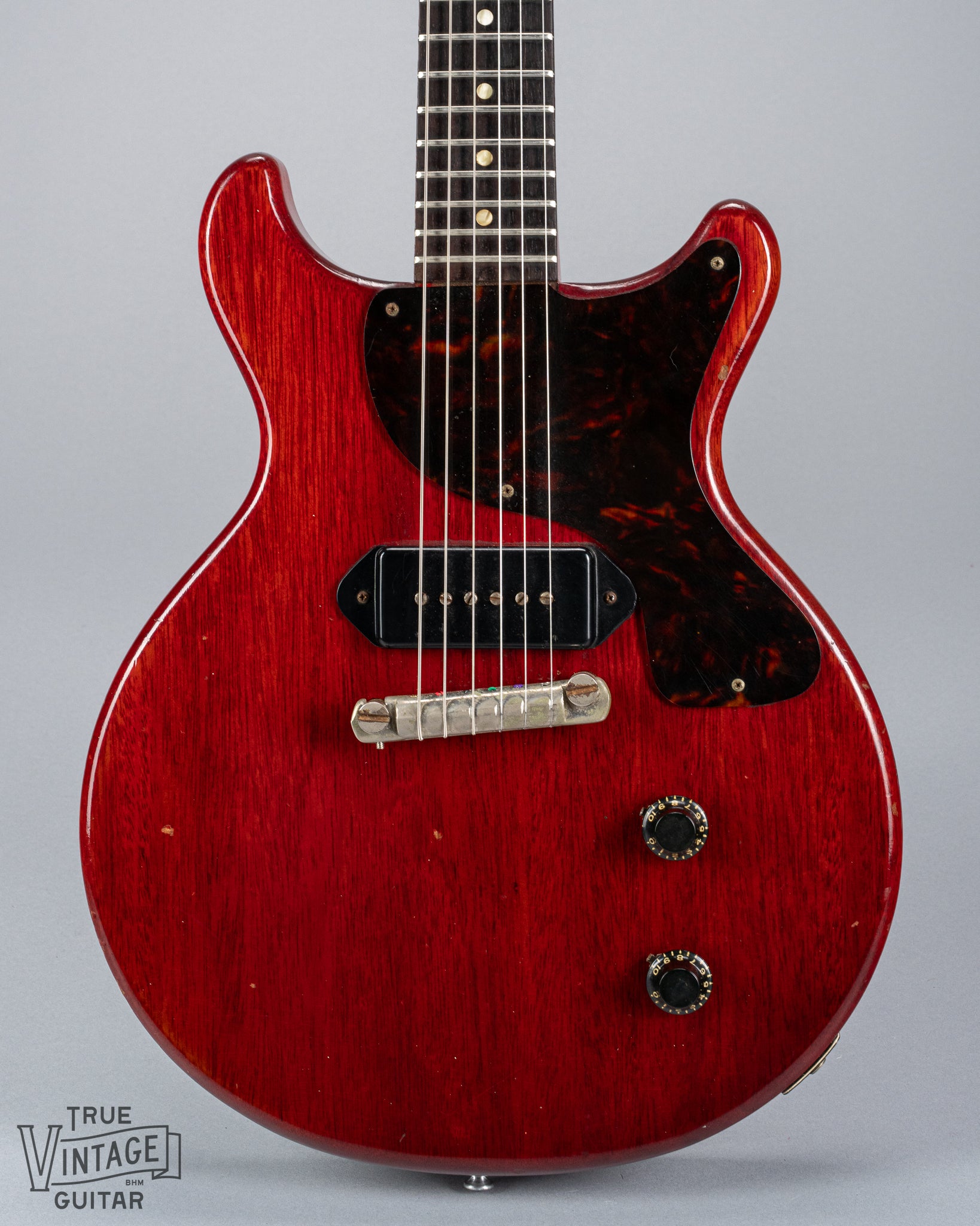 Front of 1959 Gibson Les Paul Junior cherry guitar dog ear p90 pickup tortoise pickguard volume and tone controls wrap around tail piece bridge fretboard original frets inlays