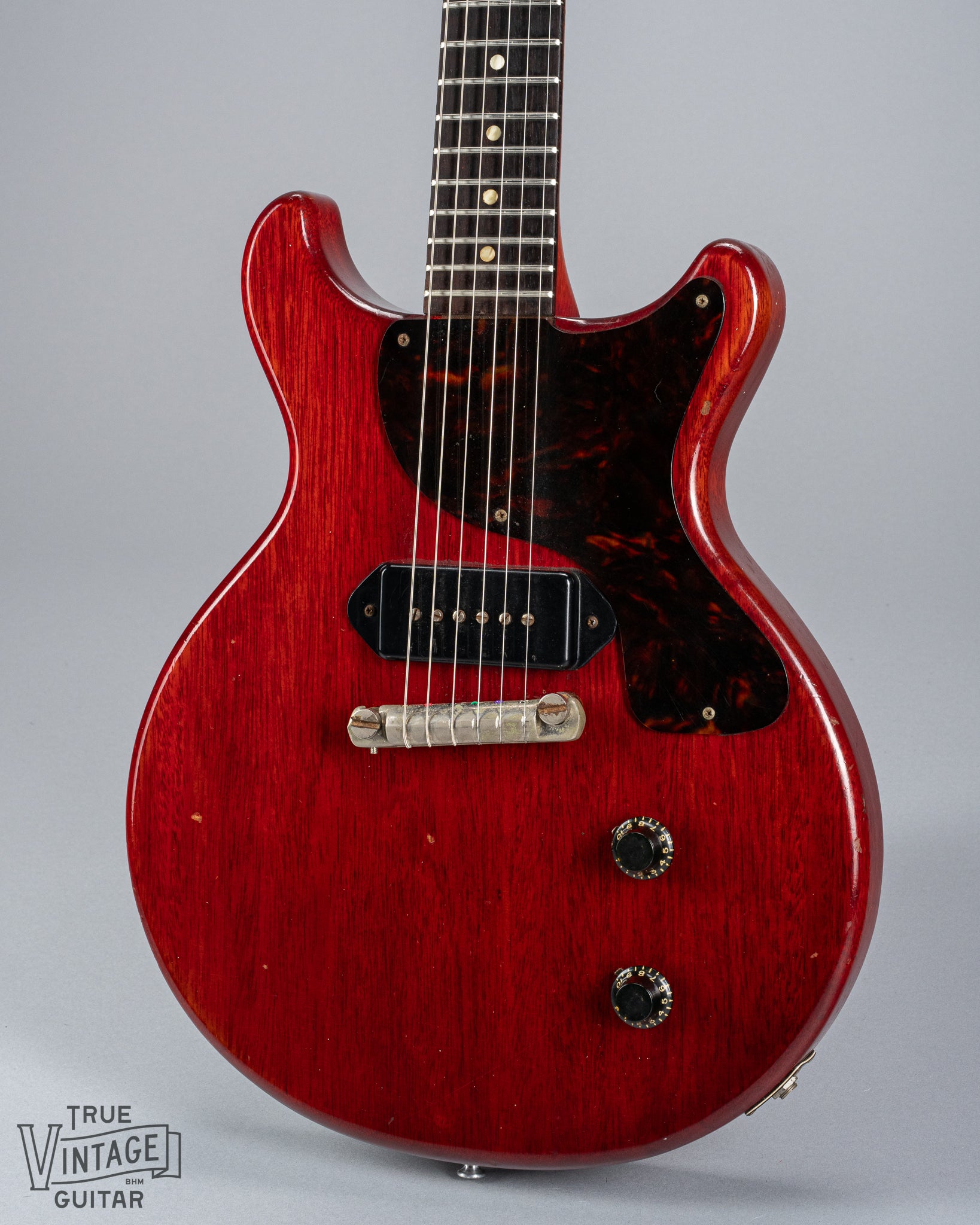 Front of 1959 Gibson Les Paul Junior cherry guitar dog ear p90 pickup tortoise pickguard volume and tone controls wrap around tail piece bridge fretboard original frets inlays
