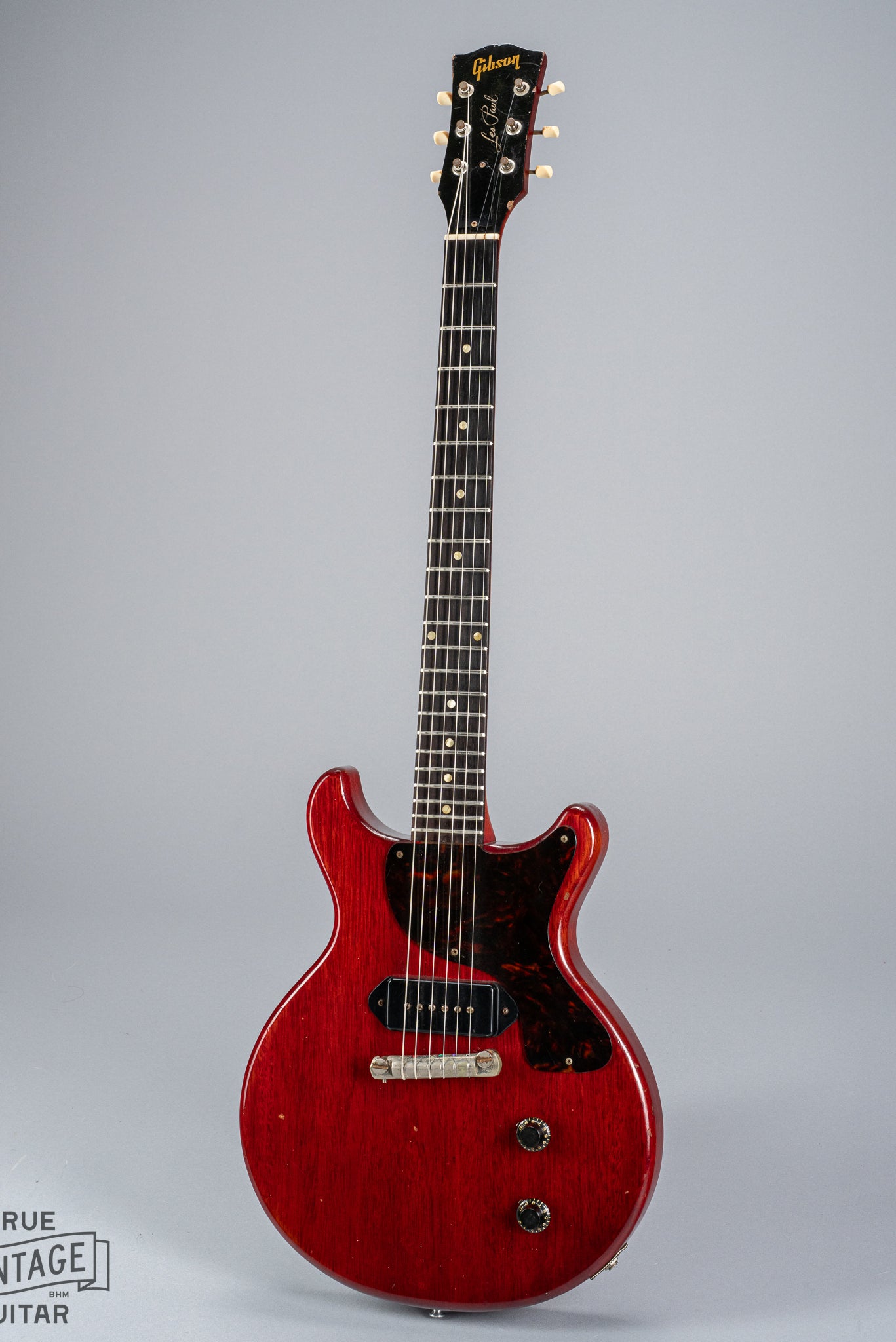Front of 1959 Gibson Les Paul Junior cherry guitar dog ear p90 pickup tortoise pickguard volume and tone controls wrap around tail piece bridge fretboard original frets inlays neck headstock logo tuners