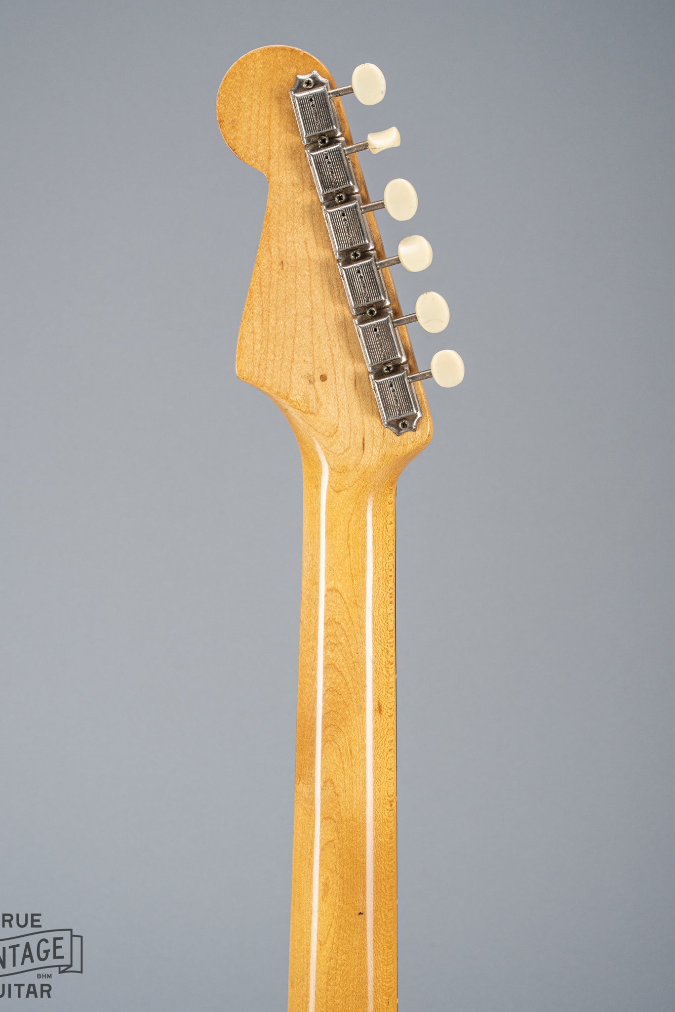 back of 1960 Fender Musicmaster desert sand guitar neck and headstock tuners