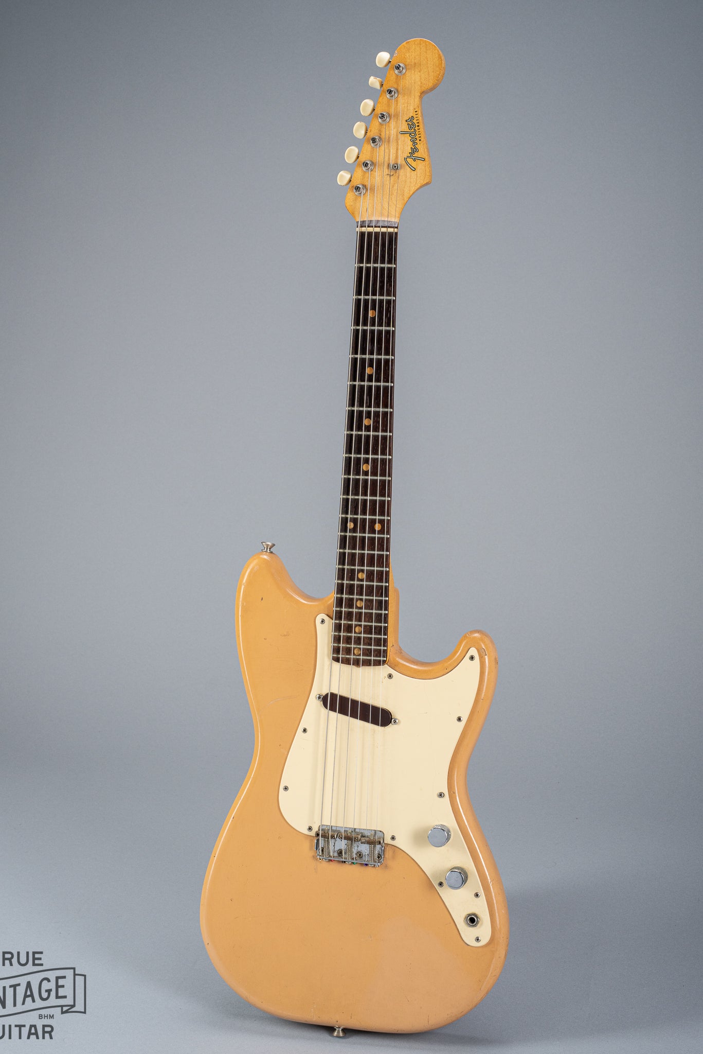 Front of 1960 Fender Musicmaster desert sand guitar body neck headstock fretboard volume tone controls single coil pickups
