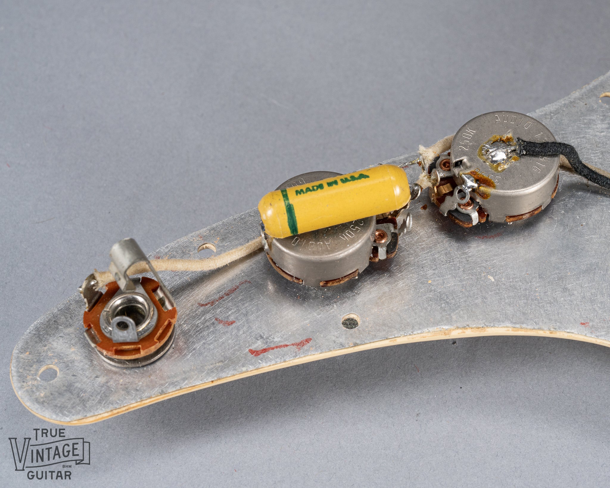 1960 Fender Musicmaster desert sand guitar electronics wiring under the pickguard pot codes