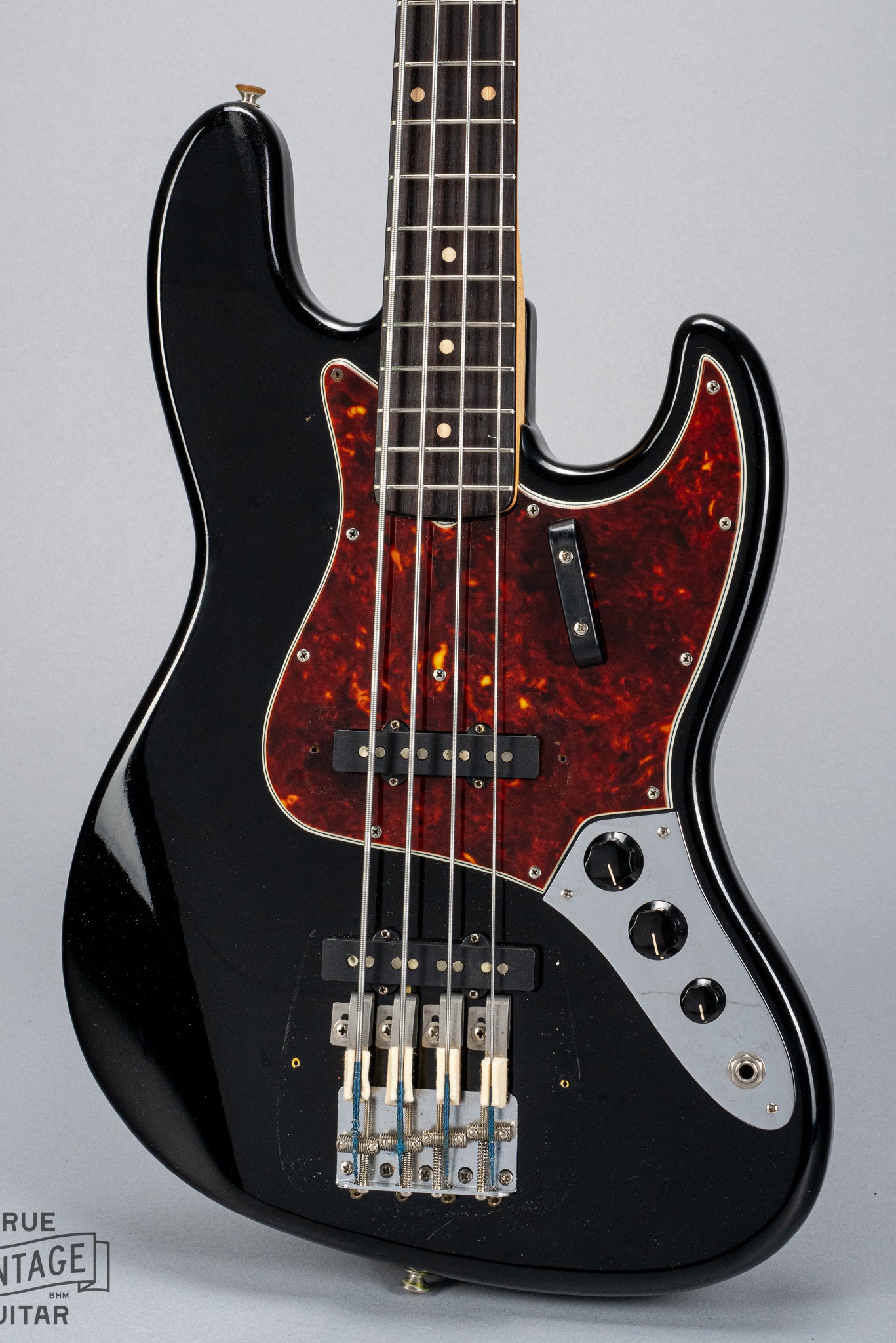 Front of 1962 Fender Jazz Bass custom color black custom color guitar tortoise shell pick guard no bridge and pickup cover
