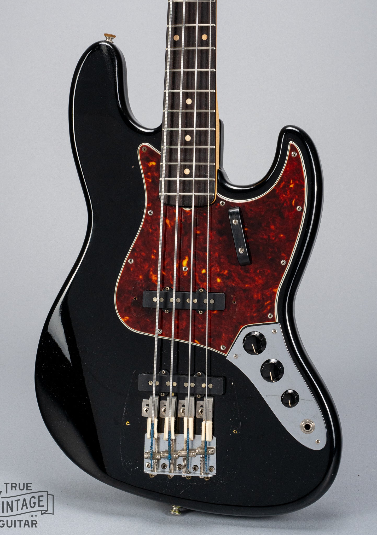 Front of 1962 Fender Jazz Bass custom color black custom color guitar tortoise shell pick guard no bridge and pickup cover