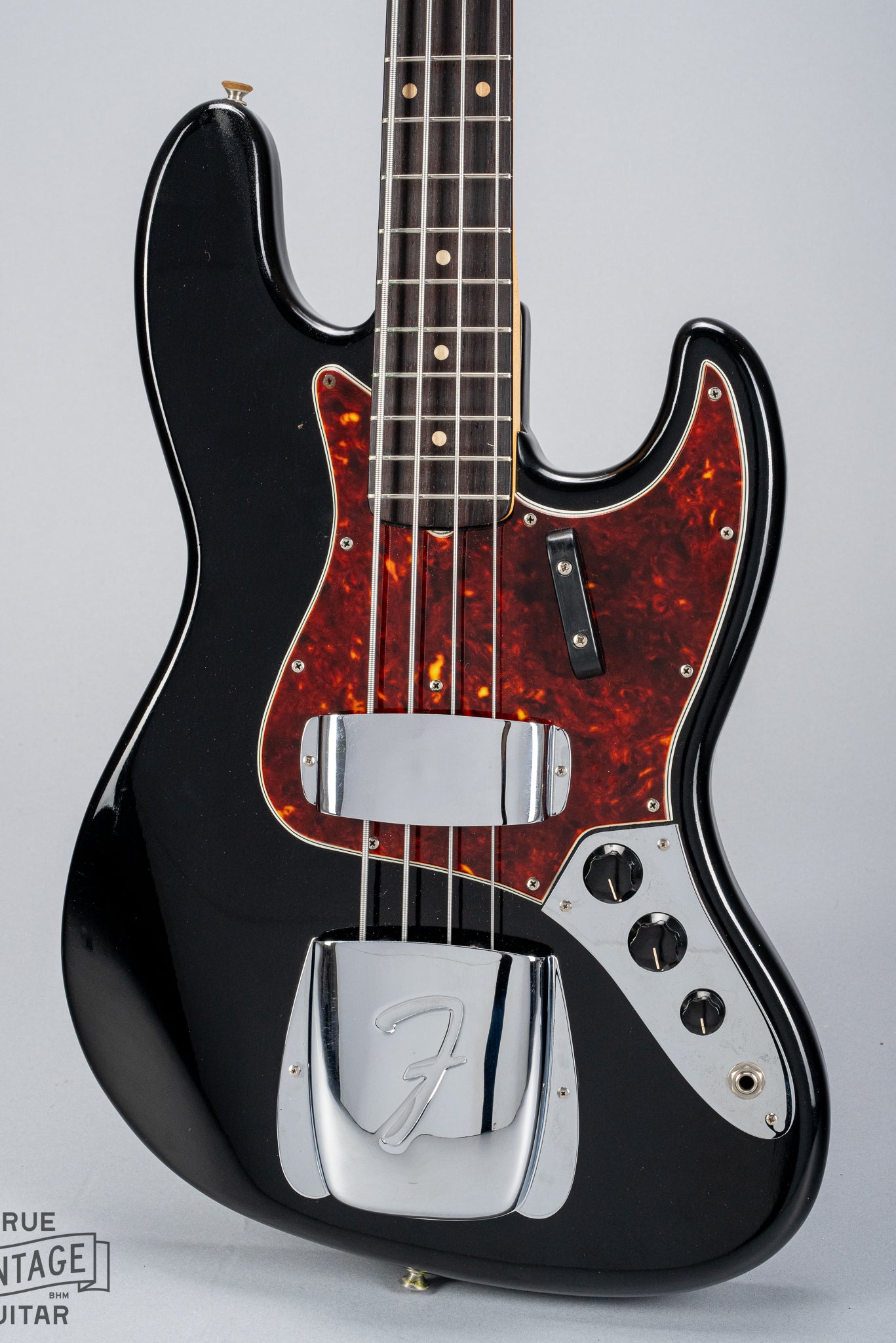 Front of 1962 Fender Jazz Bass custom color black custom color guitar tortoise shell pick guard