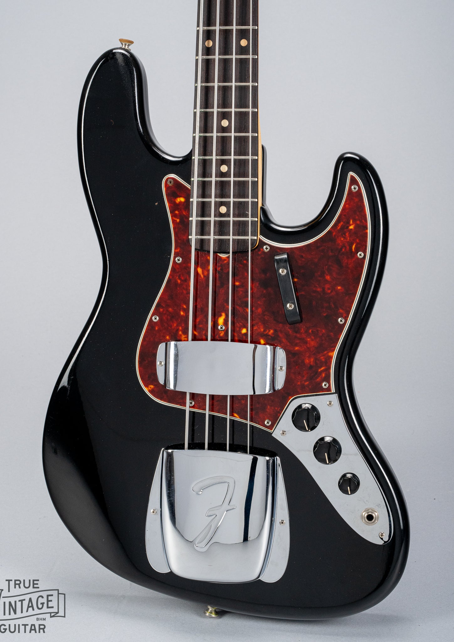 Front of 1962 Fender Jazz Bass custom color black custom color guitar tortoise shell pick guard