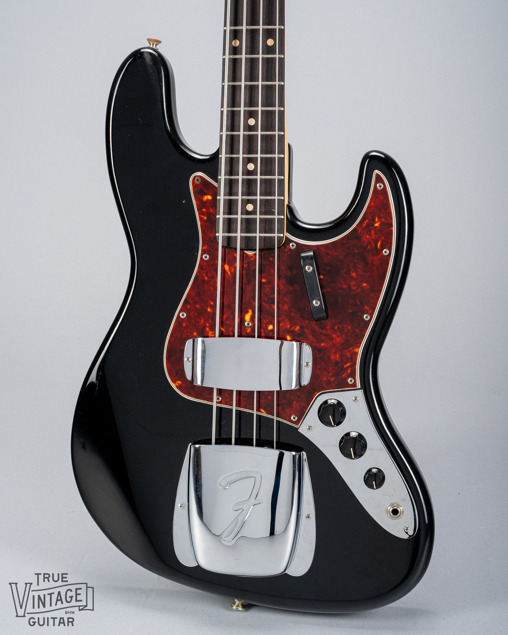 Front of 1962 Fender Jazz Bass custom color black custom color guitar tortoise shell pick guard