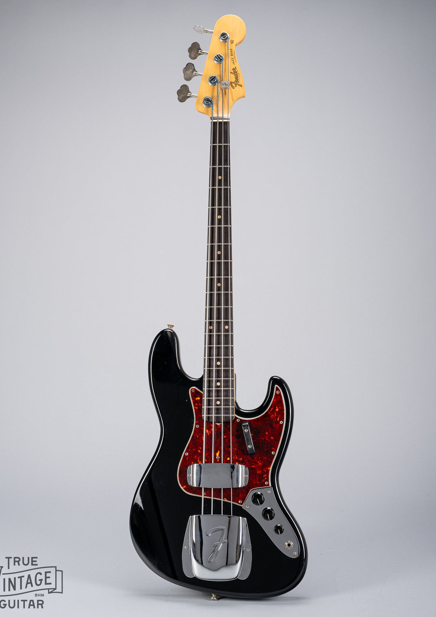 Front of 1962 Fender Jazz Bass custom color black custom color guitar tortoise shell pick guard fretboard headstock tuners