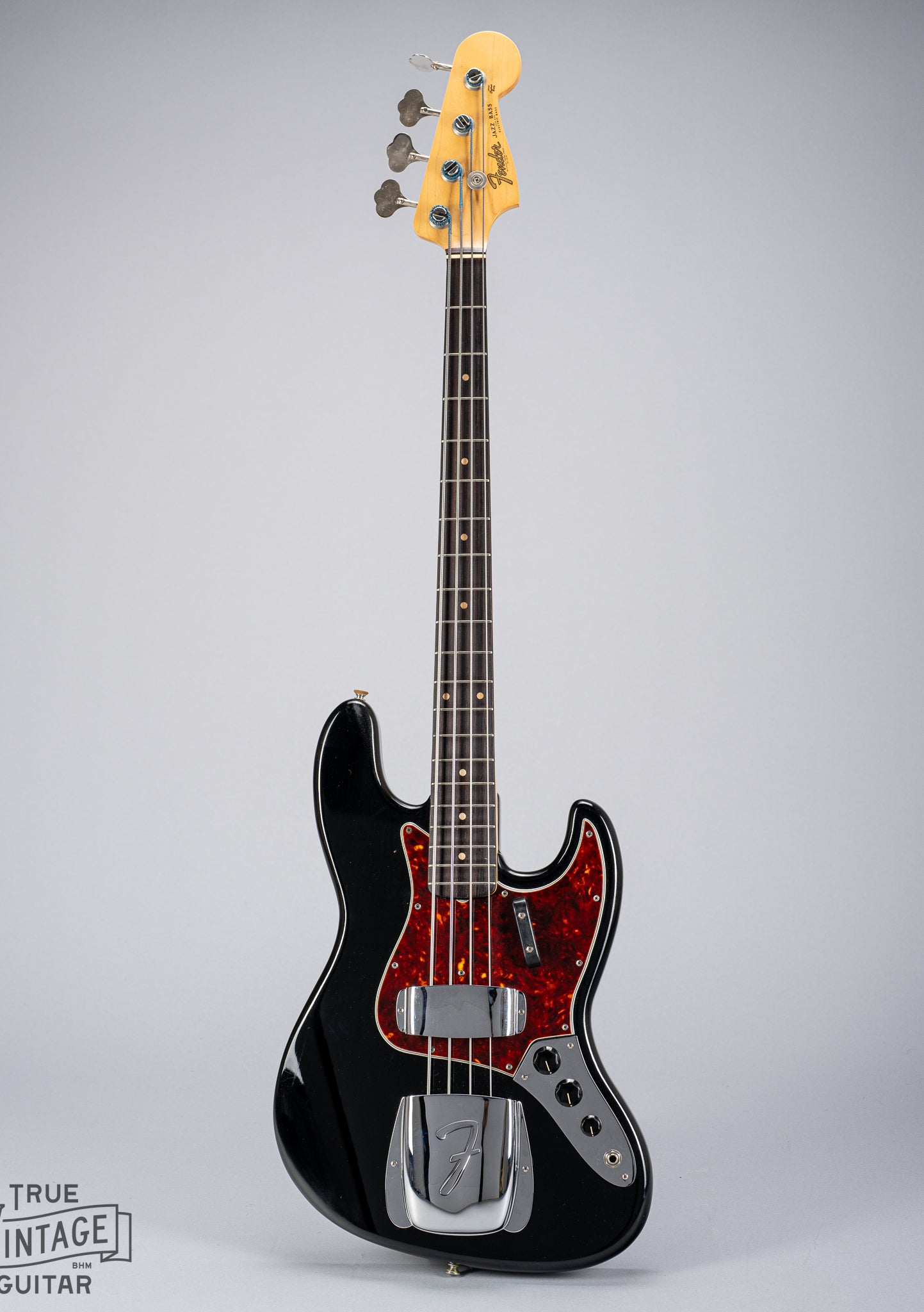 Front of 1962 Fender Jazz Bass custom color black custom color guitar tortoise shell pick guard fretboard headstock tuners