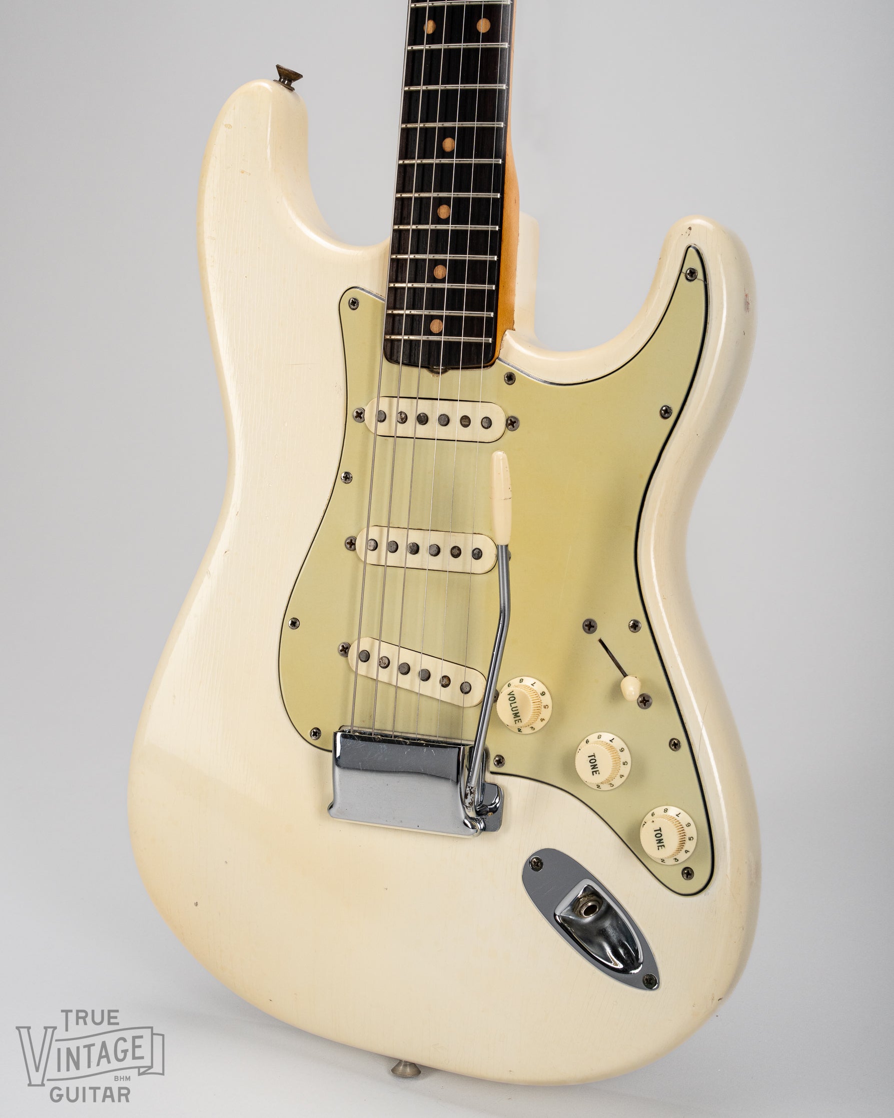 Finish checking on original Fender custom color Olympic White from 1962