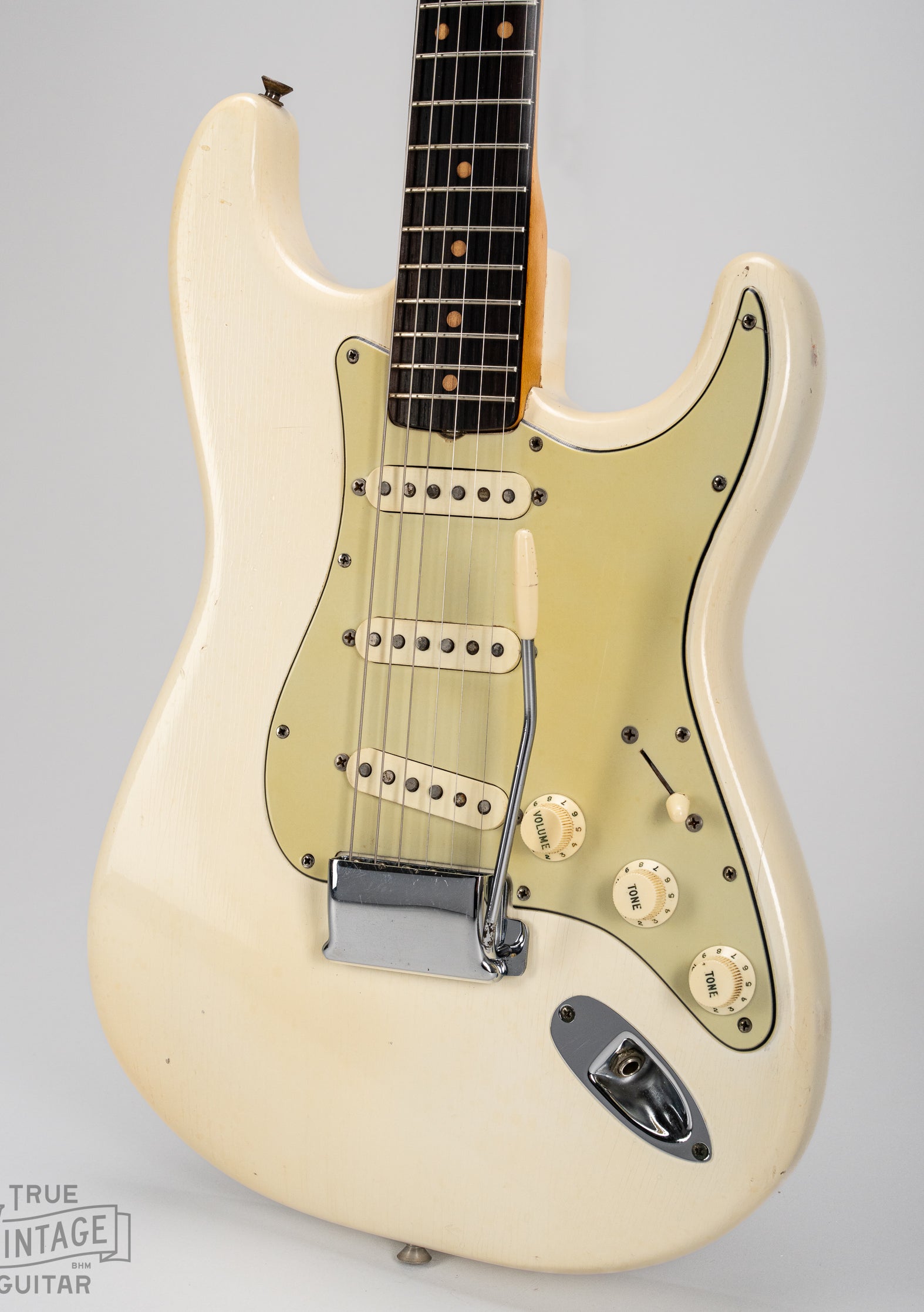 Finish checking on original Fender custom color Olympic White from 1962