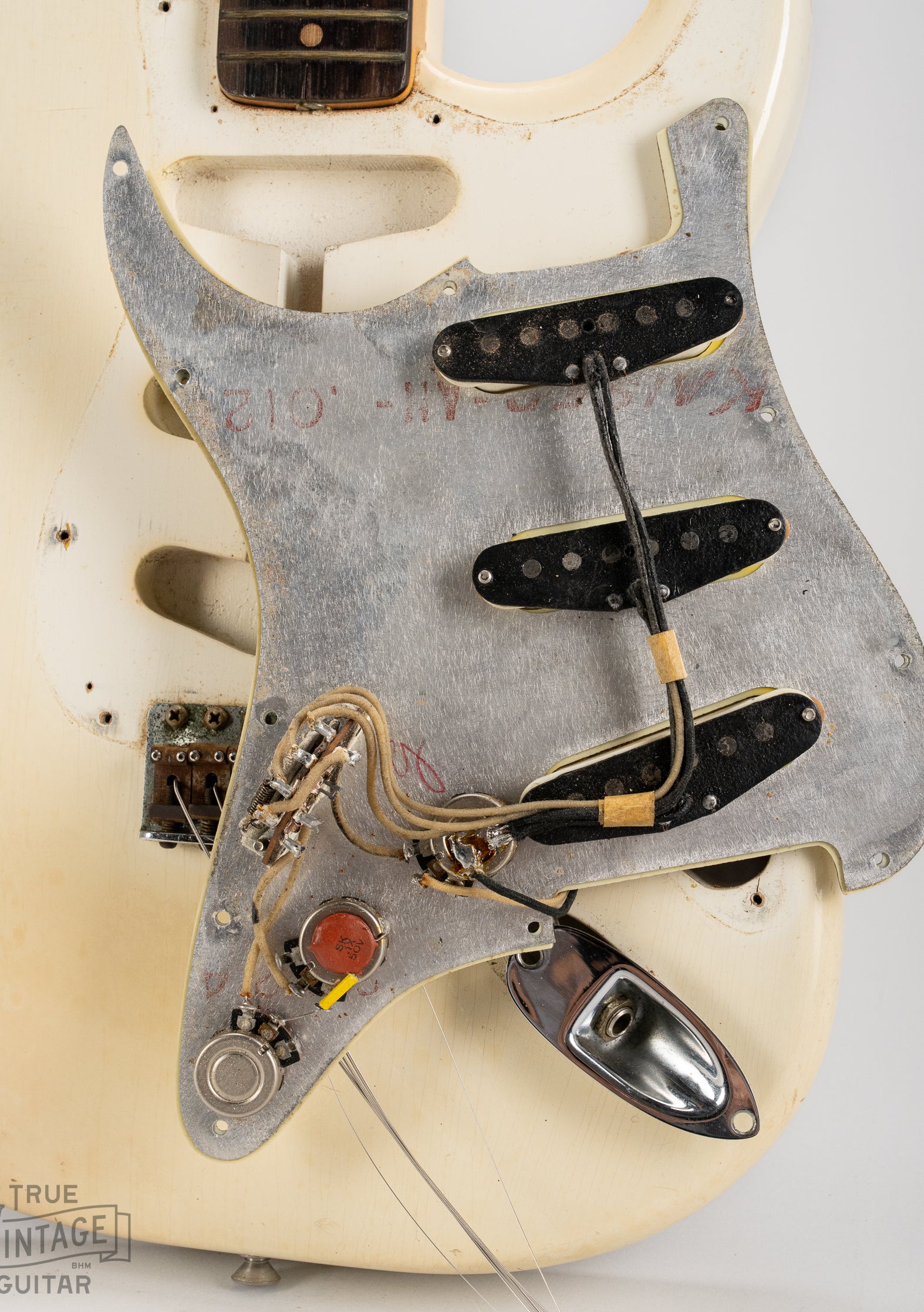 Underside of the pickguard with black bobbin pickups, potentiometers, capacitor, switch