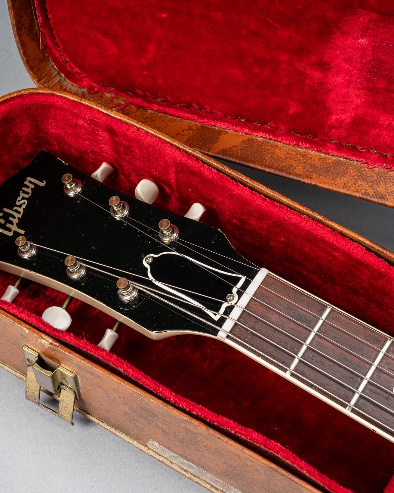 Front of 1962 Gibson SG Special white guitar headstock in Gibson hardshell case