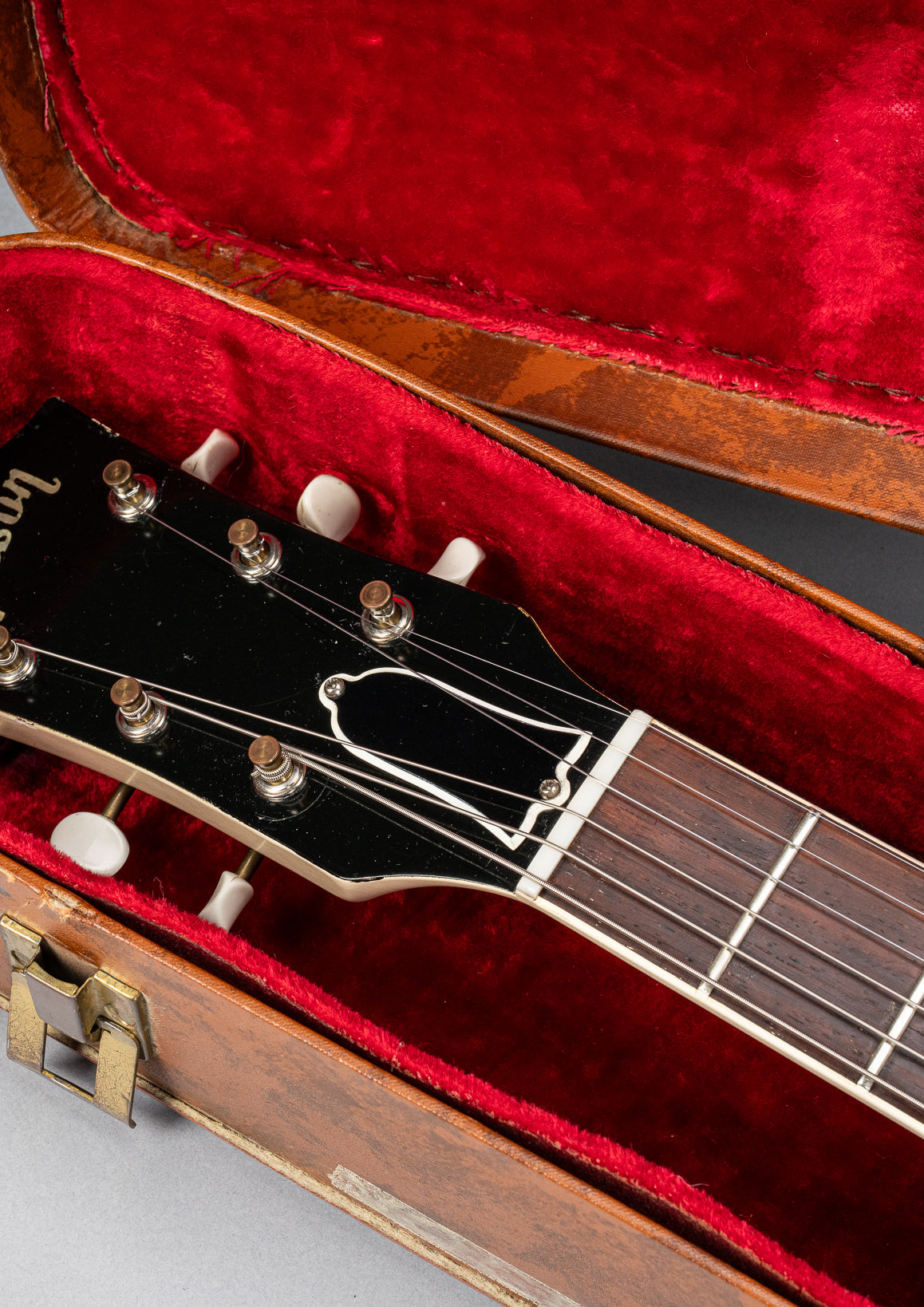 Front of 1962 Gibson SG Special white guitar headstock in Gibson hardshell case