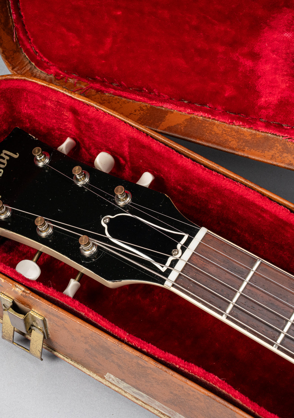 Front of 1962 Gibson SG Special white guitar headstock in Gibson hardshell case