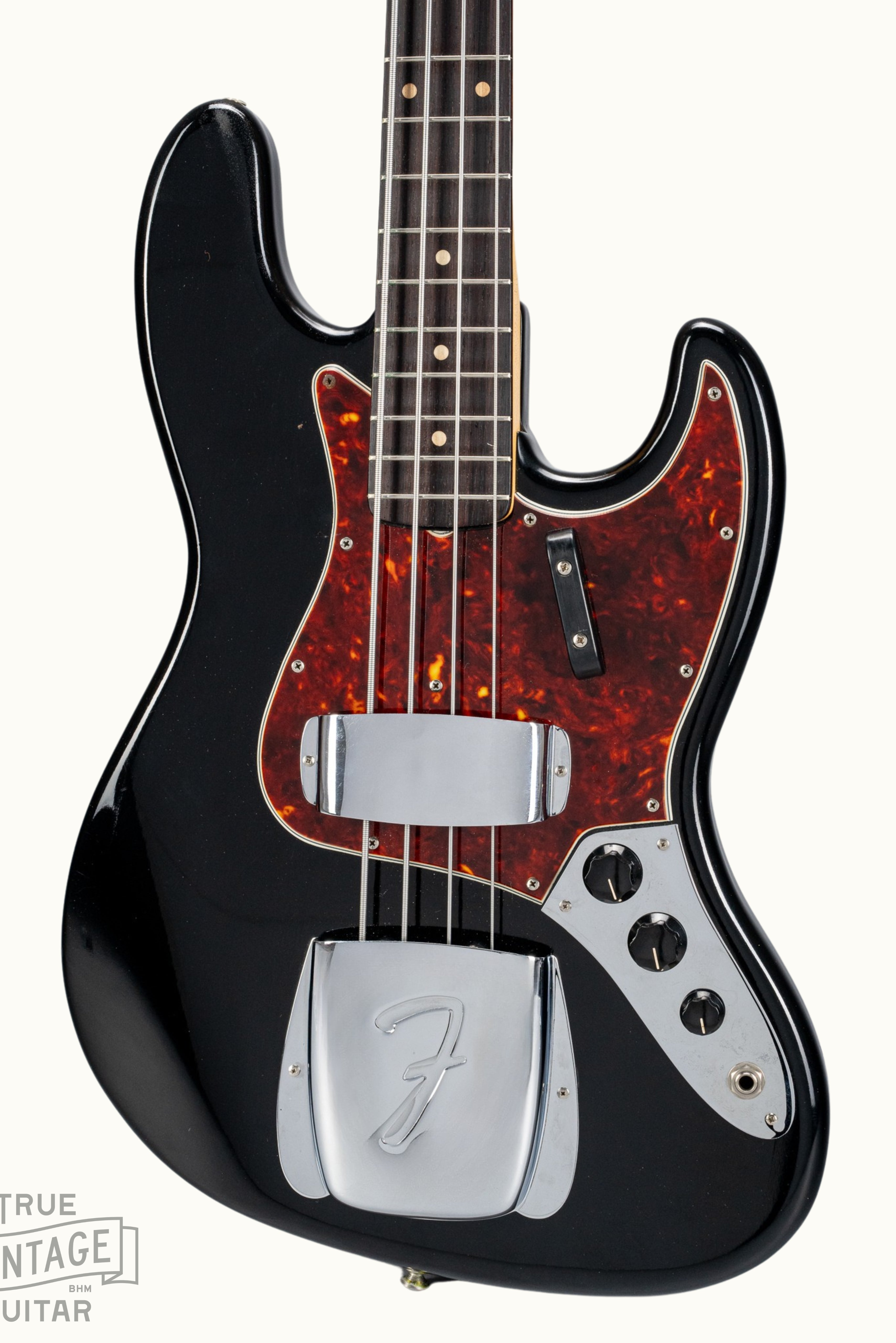 Front of 1962 Fender Jazz Bass custom color black custom color guitar tortoise shell pick guard