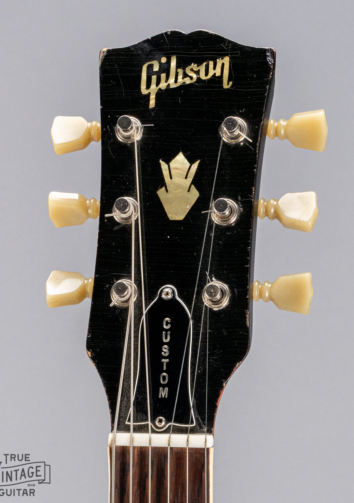 front of Gibson 1963 ES-335 Cherry red guitar Custom headstock and Gibson logo