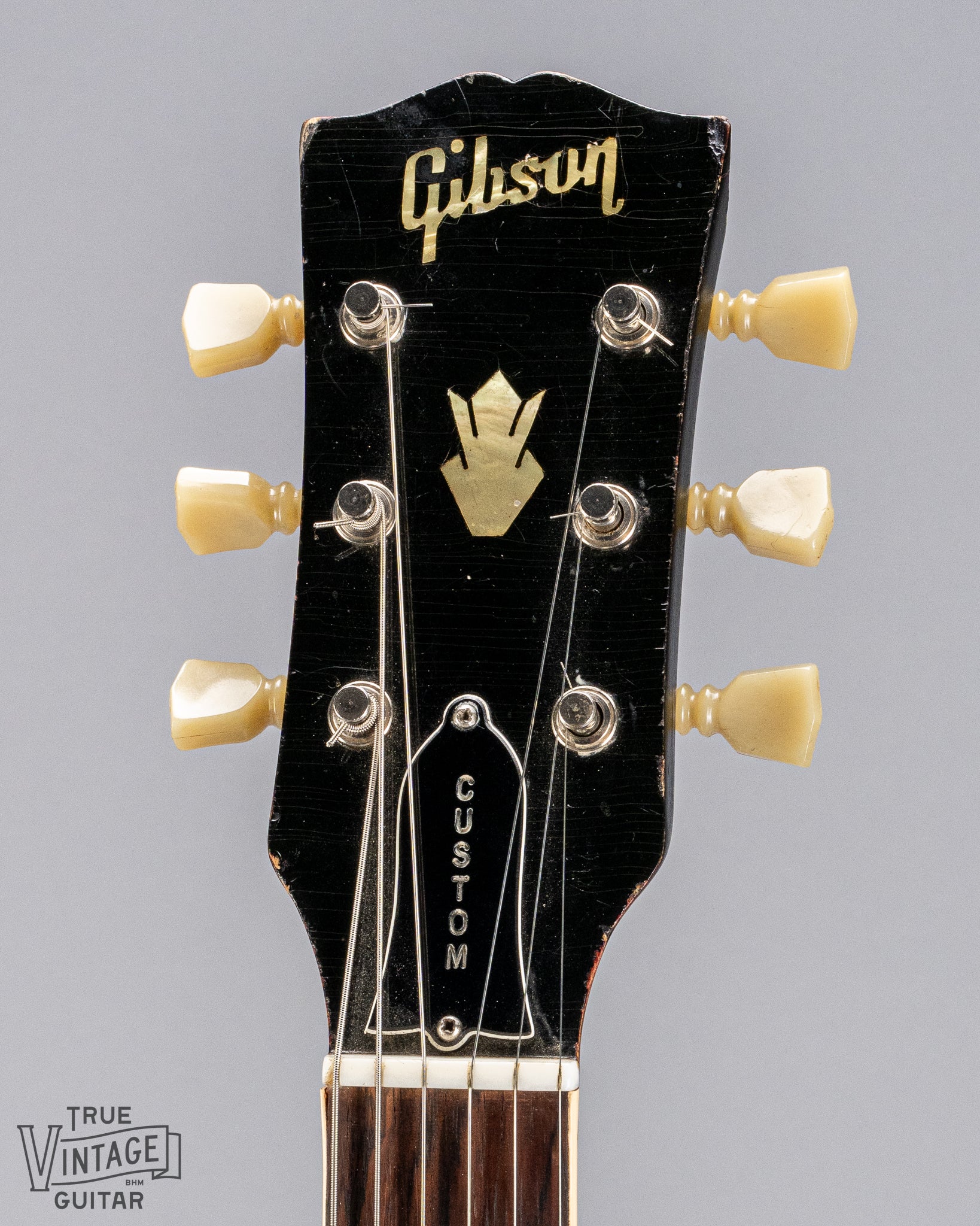 front of Gibson 1963 ES-335 Cherry red guitar Custom headstock and Gibson logo