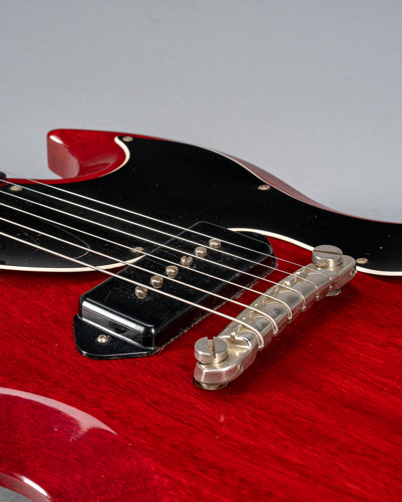 Front of Gibson Les Paul Junior Cherry red guitar body P90 pickup and warped pickguard