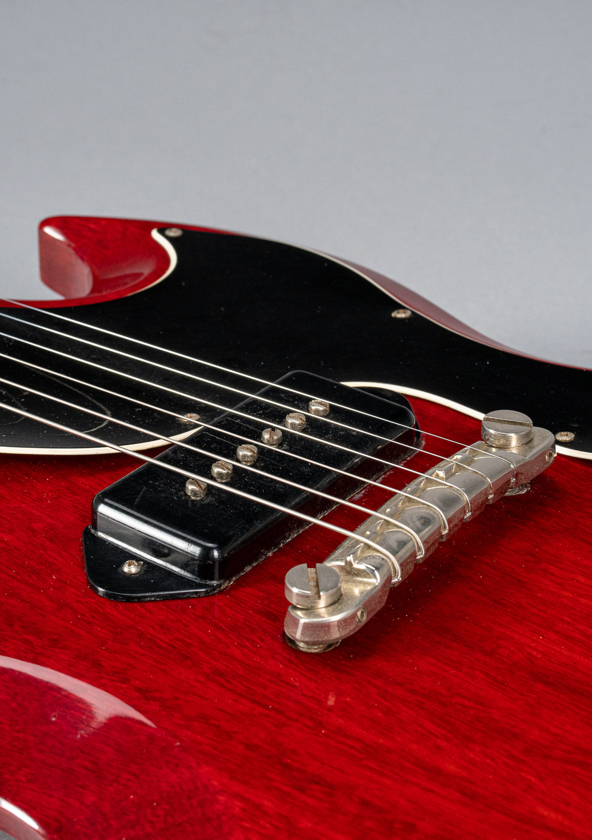 Front of Gibson Les Paul Junior Cherry red guitar body P90 pickup and warped pickguard