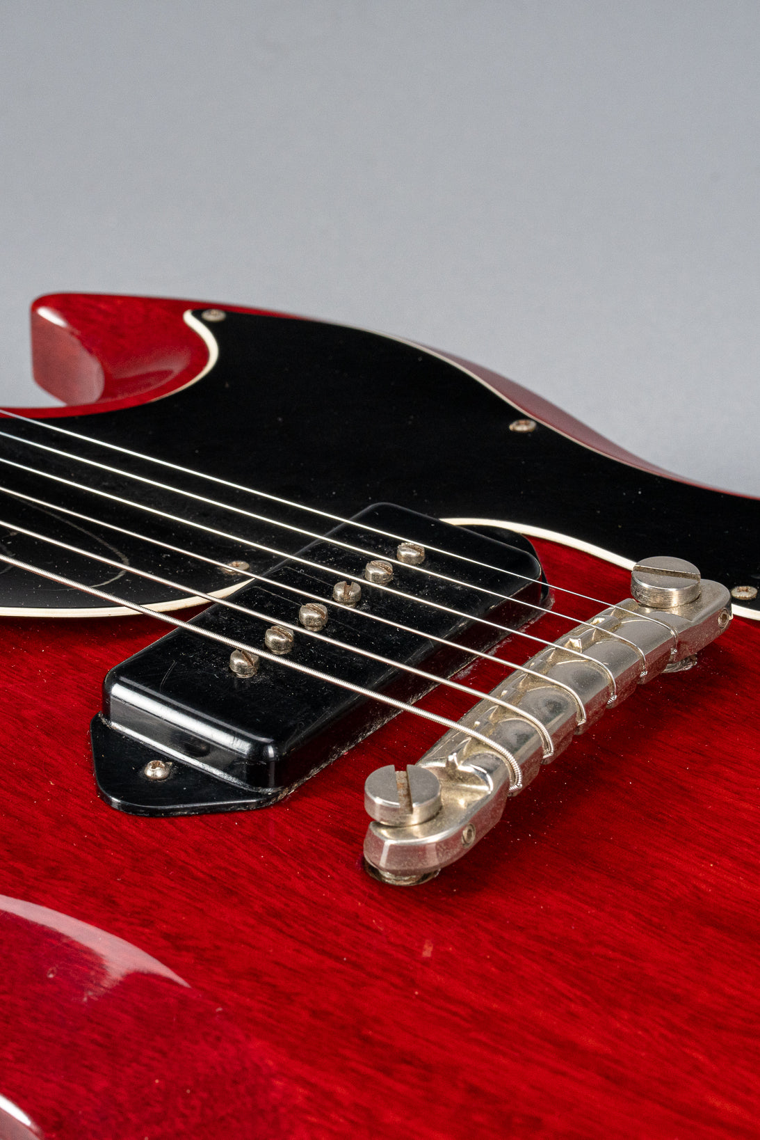 Front of Gibson Les Paul Junior Cherry red guitar body P90 pickup and warped pickguard