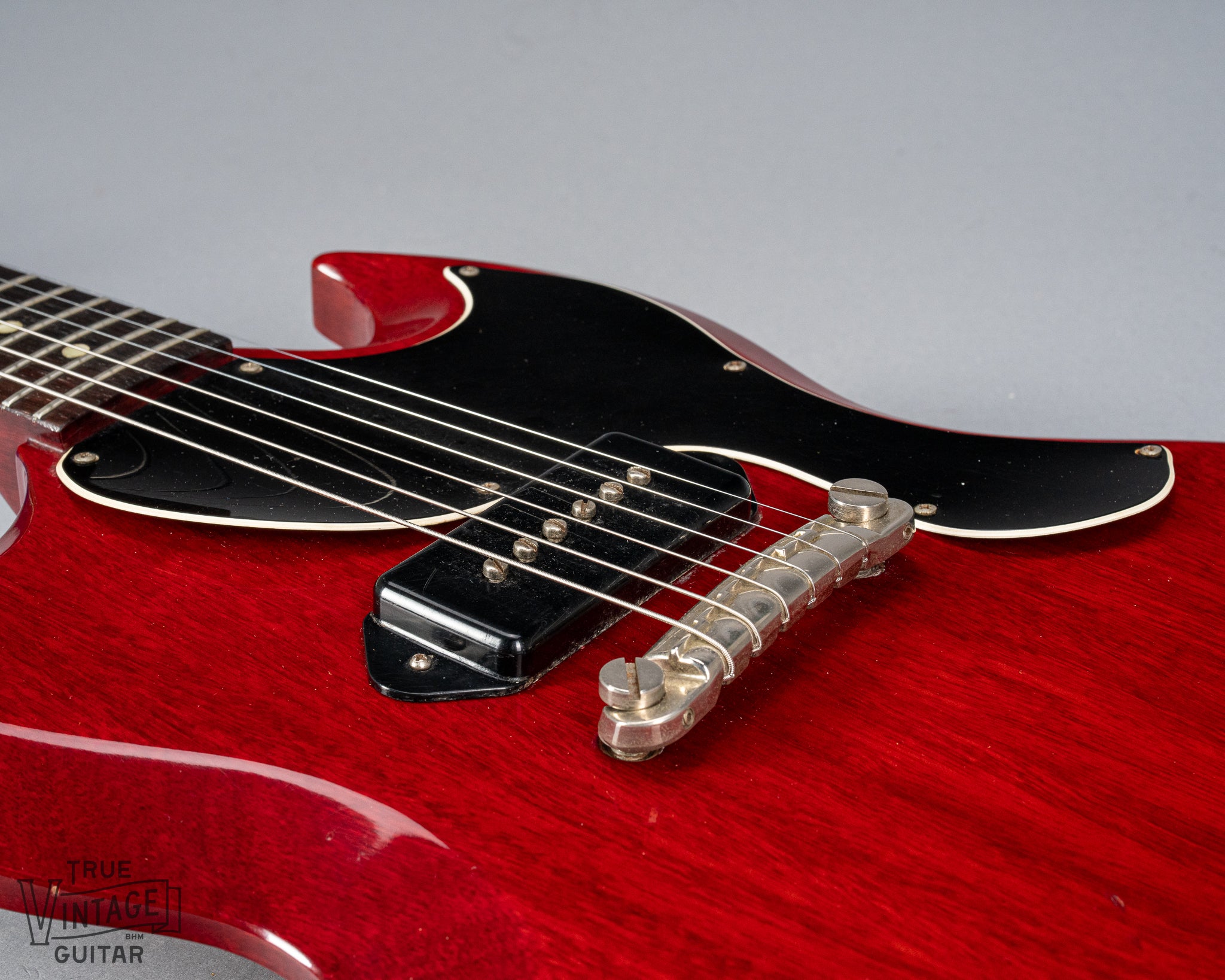 Front of Gibson Les Paul Junior Cherry red guitar body P90 pickup and warped pickguard