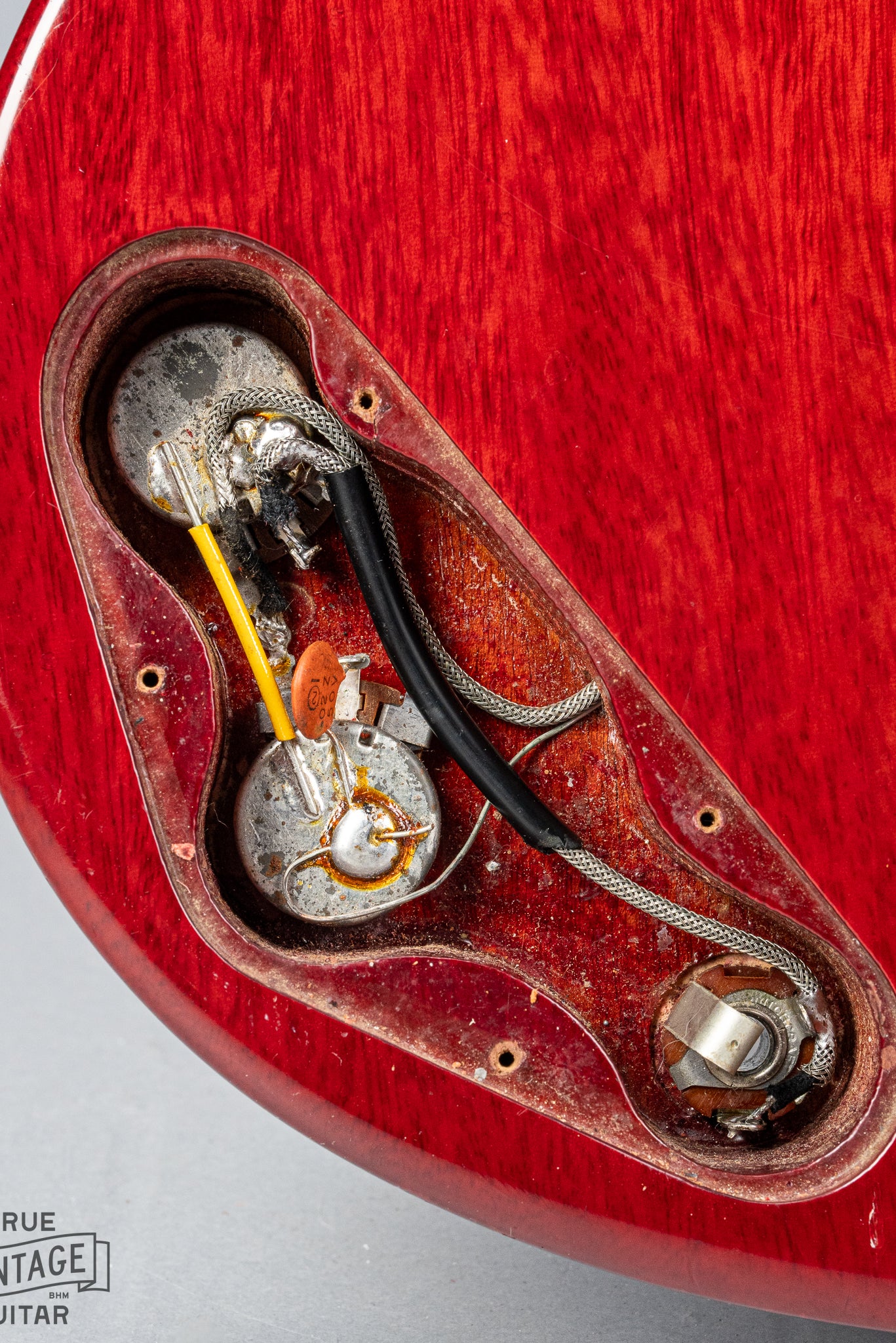 Front of Gibson Les Paul Junior Cherry red guitar control cavity electronics pots wiring output jack