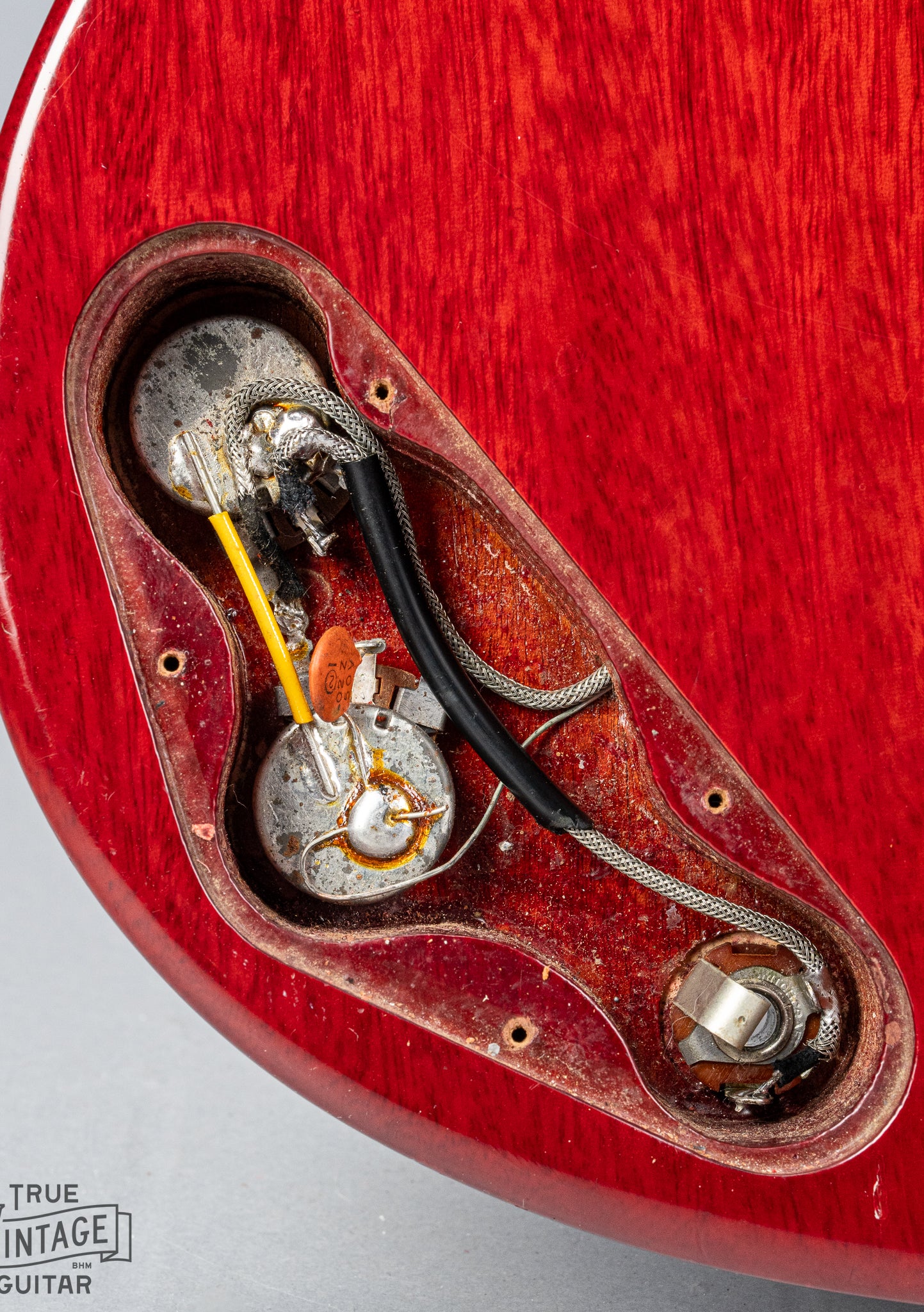 Front of Gibson Les Paul Junior Cherry red guitar control cavity electronics pots wiring output jack