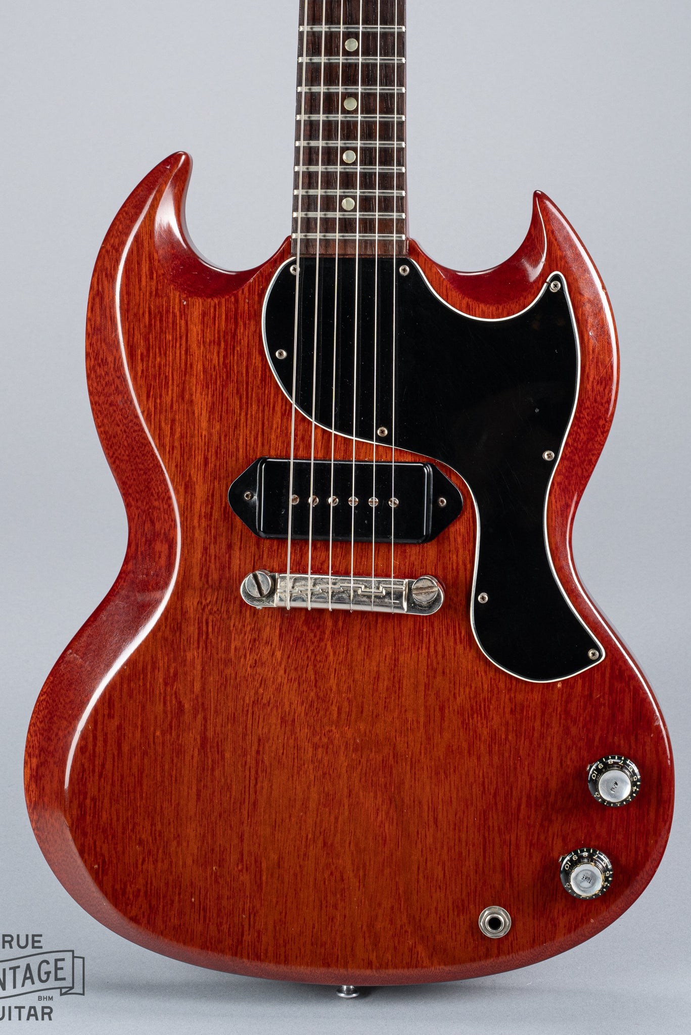 Front of 1964 Gibson SG Junior Cherry guitar body pickguard dog ear P90 bridge wrap around tailpiece volume and tone controls fretboard original frets