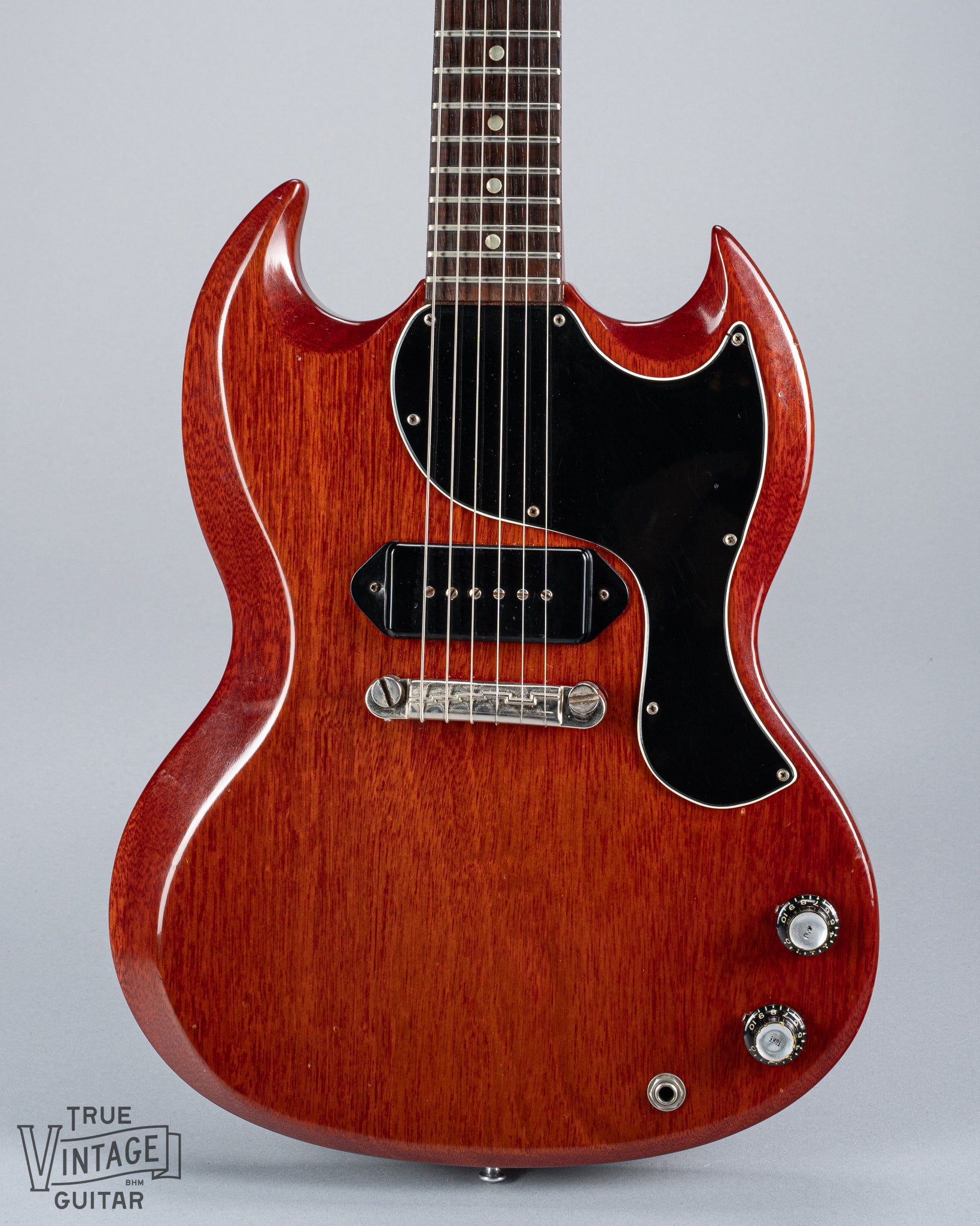 Front of 1964 Gibson SG Junior Cherry guitar body pickguard dog ear P90 bridge wrap around tailpiece volume and tone controls fretboard original frets