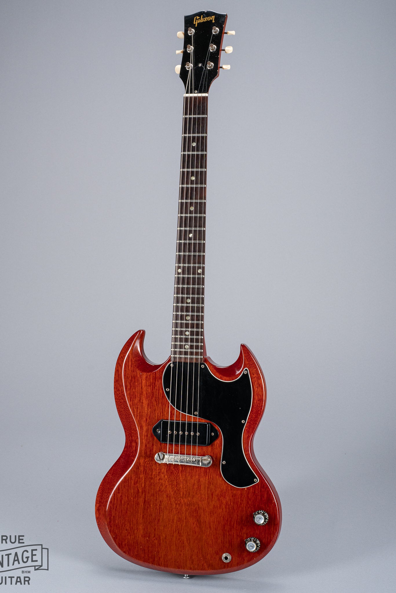 Front of 1964 Gibson SG Junior Cherry body pickguard dog ear P90 bridge wrap around tailpiece volume and tone controls fretboard original frets headstock tuners Gibson logo