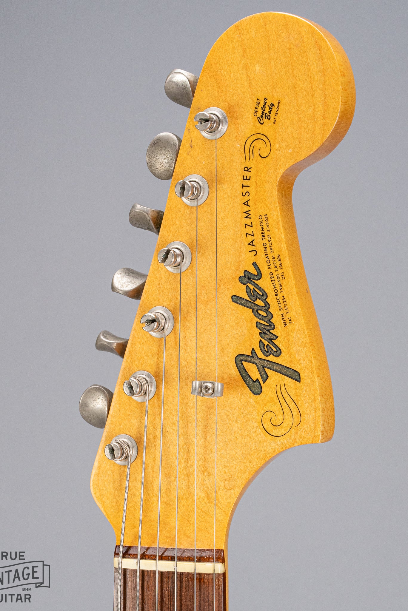 Front of 1965 Fender Jazzmaster sunburst guitar fender logo and tuners