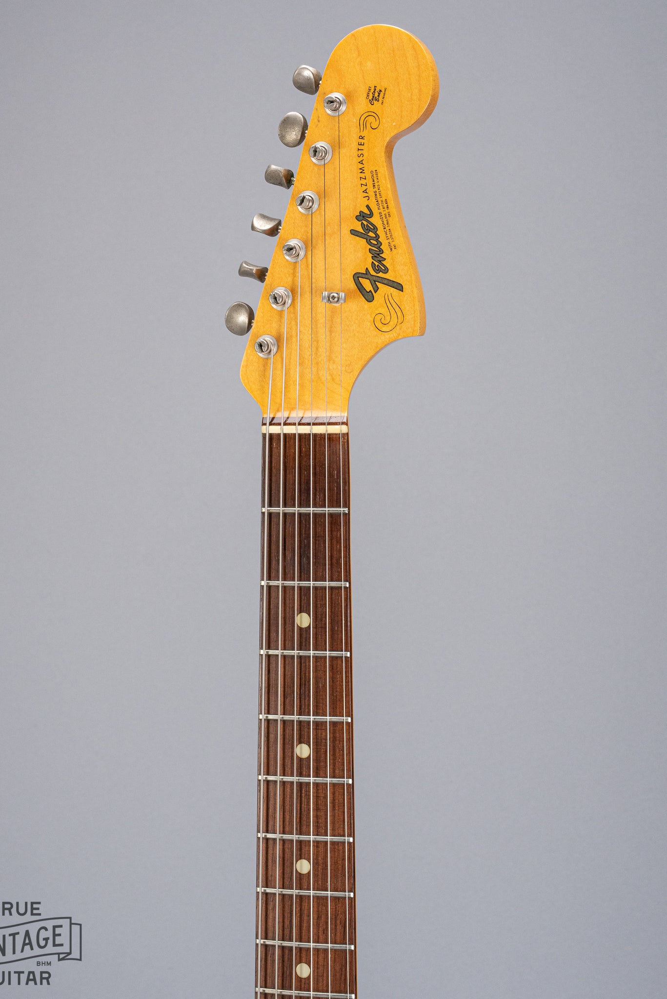 Front of 1965 Fender Jazzmaster sunburst guitar neck and headstock logo
