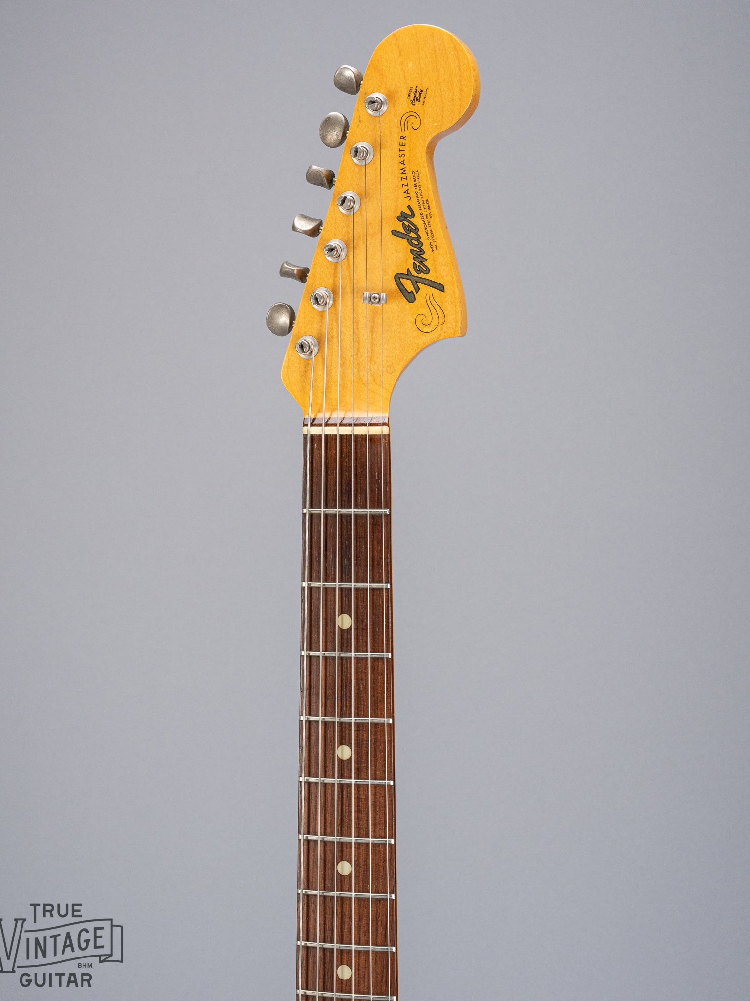 Front of 1965 Fender Jazzmaster sunburst guitar neck and headstock logo