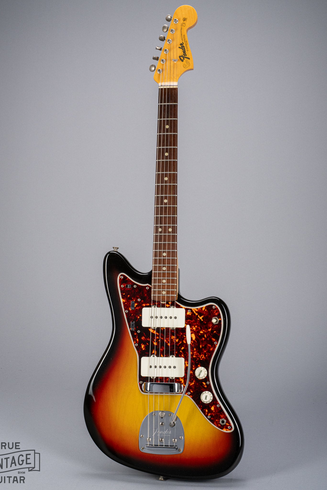 Front of 1965 Fender Jazzmaster sunburst guitar body tortoise shell pickguard pickups bridge tremolo neck and headstock