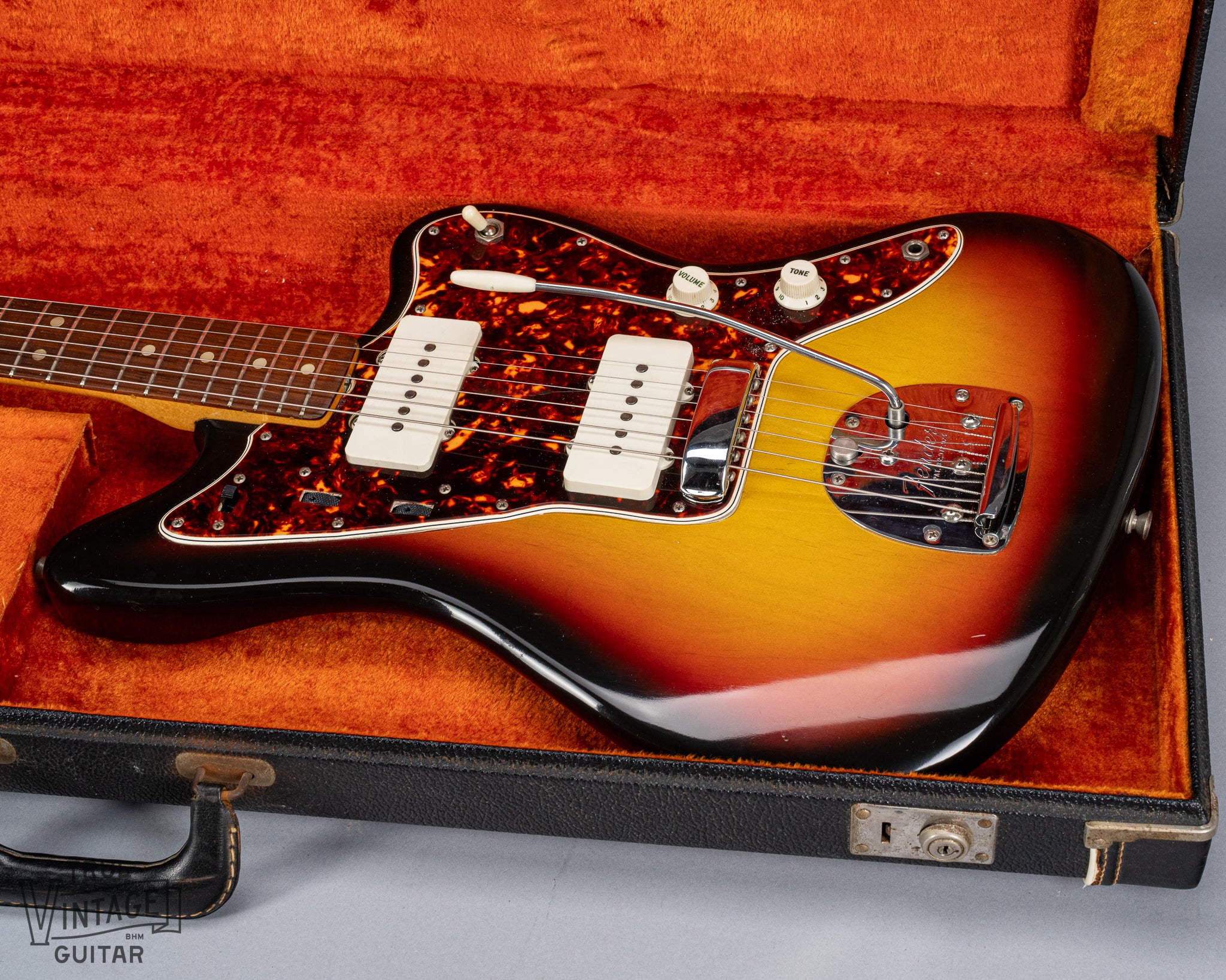 Front of 1965 Fender Jazzmaster sunburst guitar body tortoise shell pickguard in original case