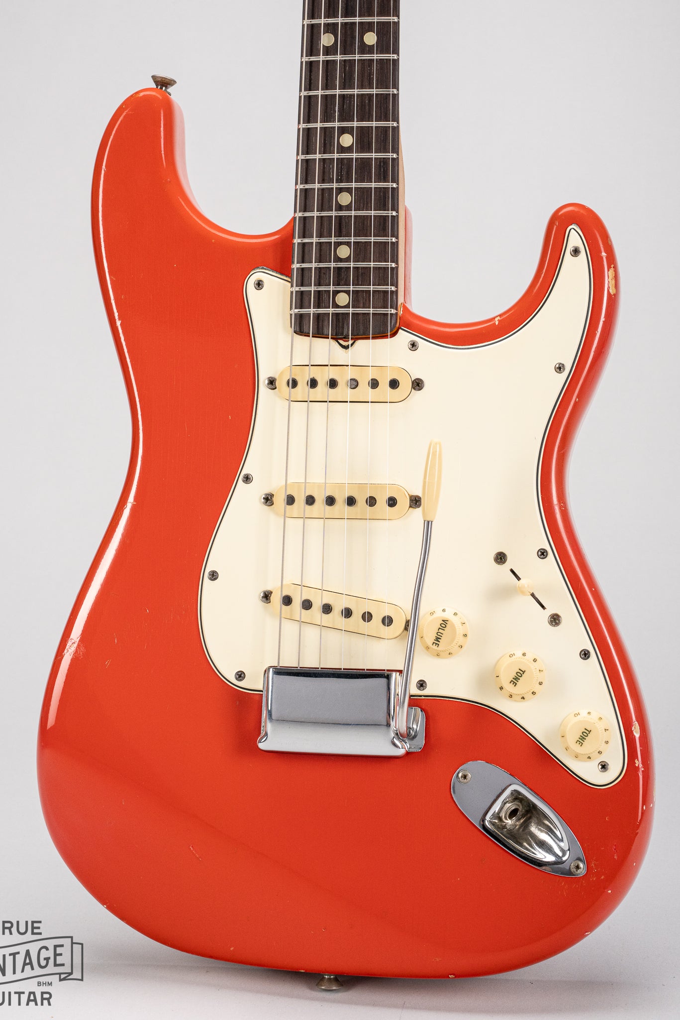 1965 Fender Stratocaster Fiesta Red custom color guitar front of body mint green pickguard single coil pickups bridge plate cover tremolo arm