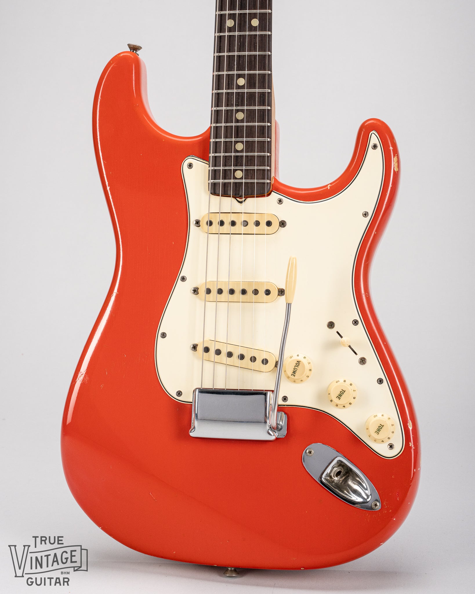 1965 Fender Stratocaster Fiesta Red custom color guitar front of body mint green pickguard single coil pickups bridge plate cover tremolo arm