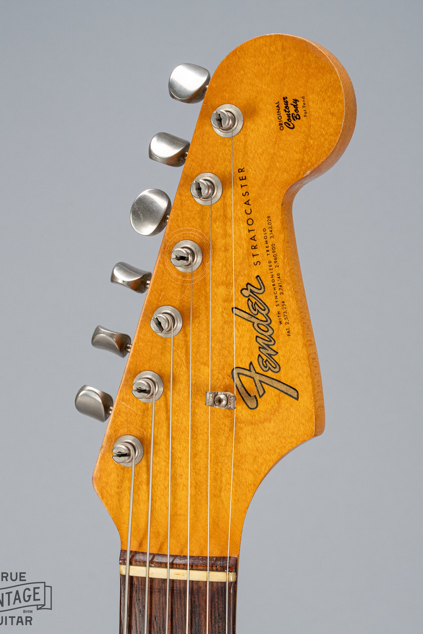 front of 1965 Fender Stratocaster Sunburst guitar headstock Fender logo nut tuning machines