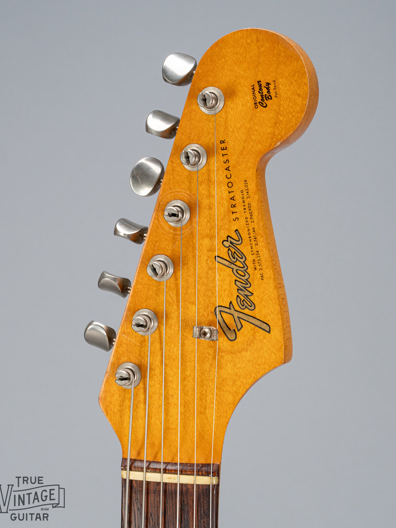 front of 1965 Fender Stratocaster Sunburst guitar headstock Fender logo nut tuning machines