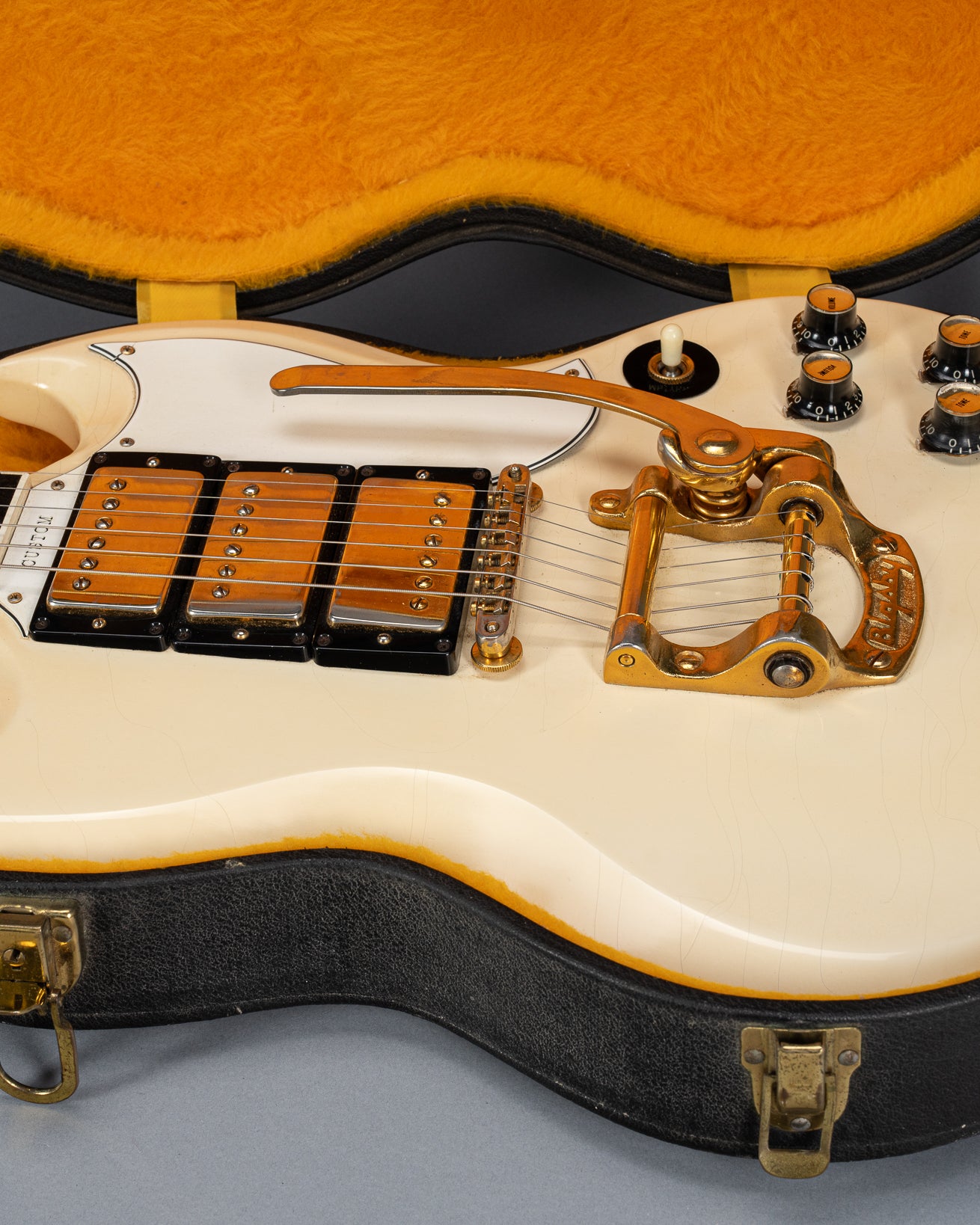 Front of 1965 Gibson SG Custom white guitar three pickup with Bigsby B5 vibrato tailpiece in original case