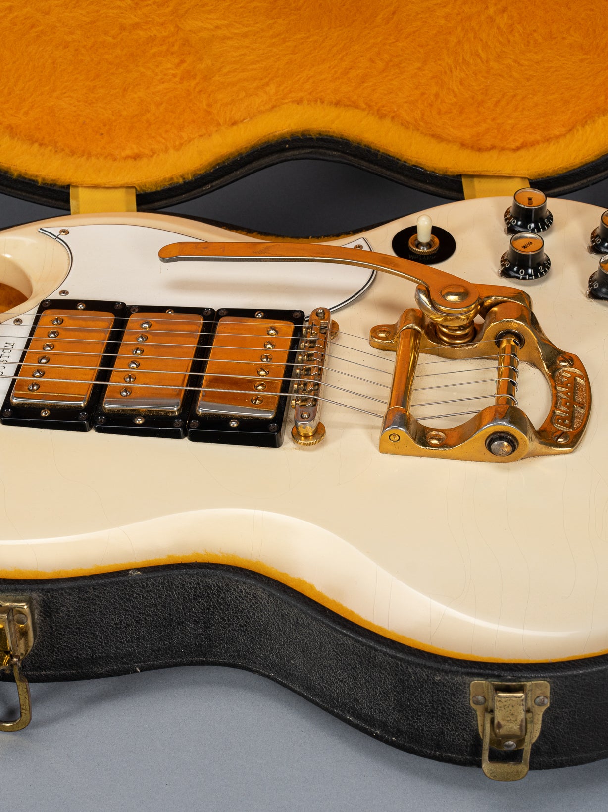 Front of 1965 Gibson SG Custom white guitar three pickup with Bigsby B5 vibrato tailpiece in original case