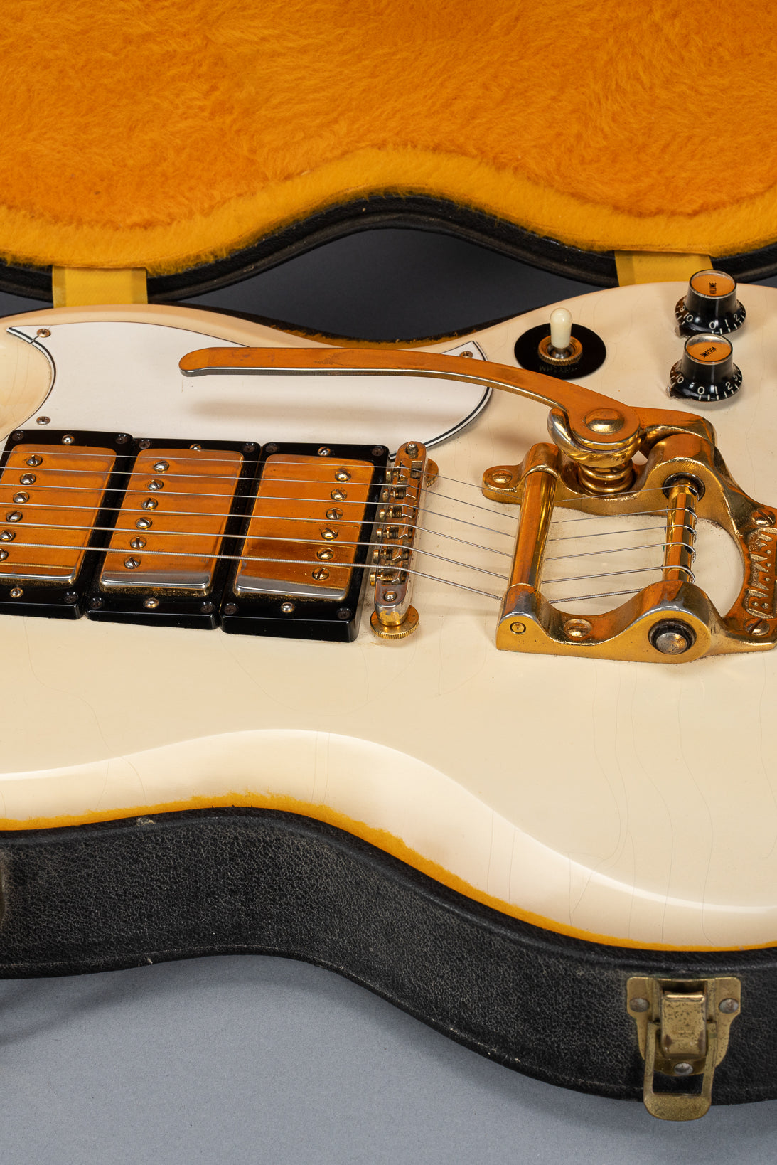 Front of 1965 Gibson SG Custom white guitar three pickup with Bigsby B5 vibrato tailpiece in original case