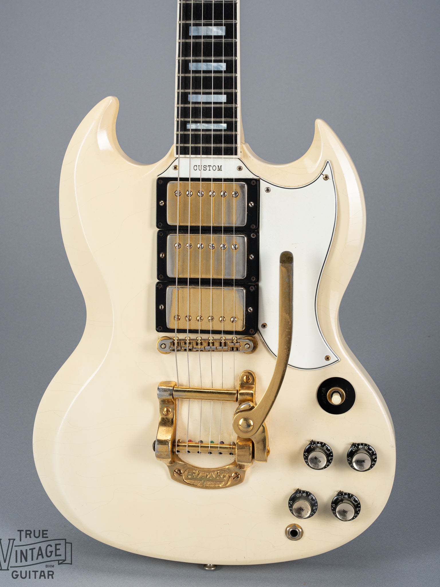 Front of 1965 Gibson SG Custom white guitar three pickup with Bigsby B5 vibrato tailpiece